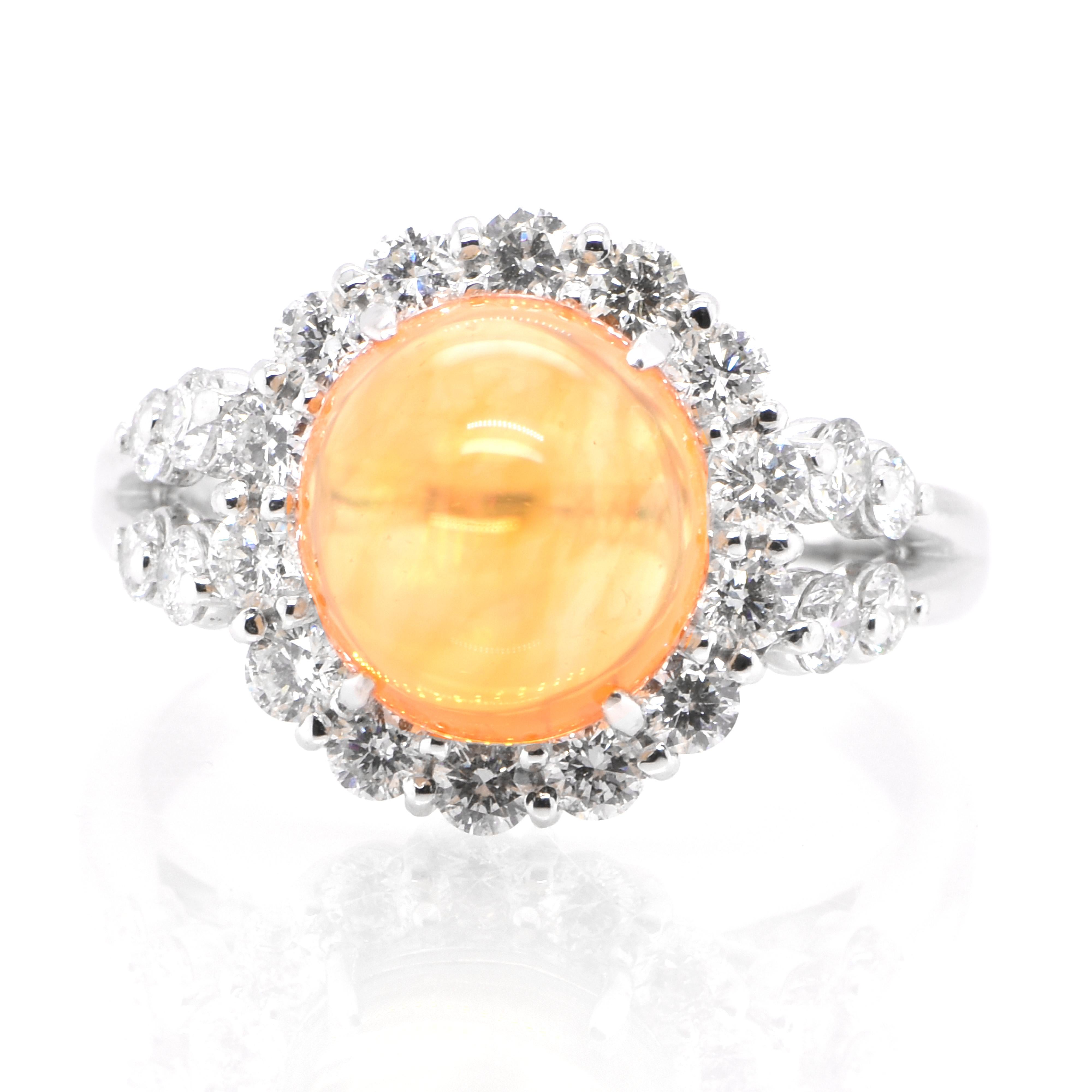 A beautiful ring featuring a 2.74 Carat Natural Mexican Fire Opal and 0.85 Carats of Diamond Accents set in Platinum. Opals are known for exhibiting flashes of rainbow colors known as 