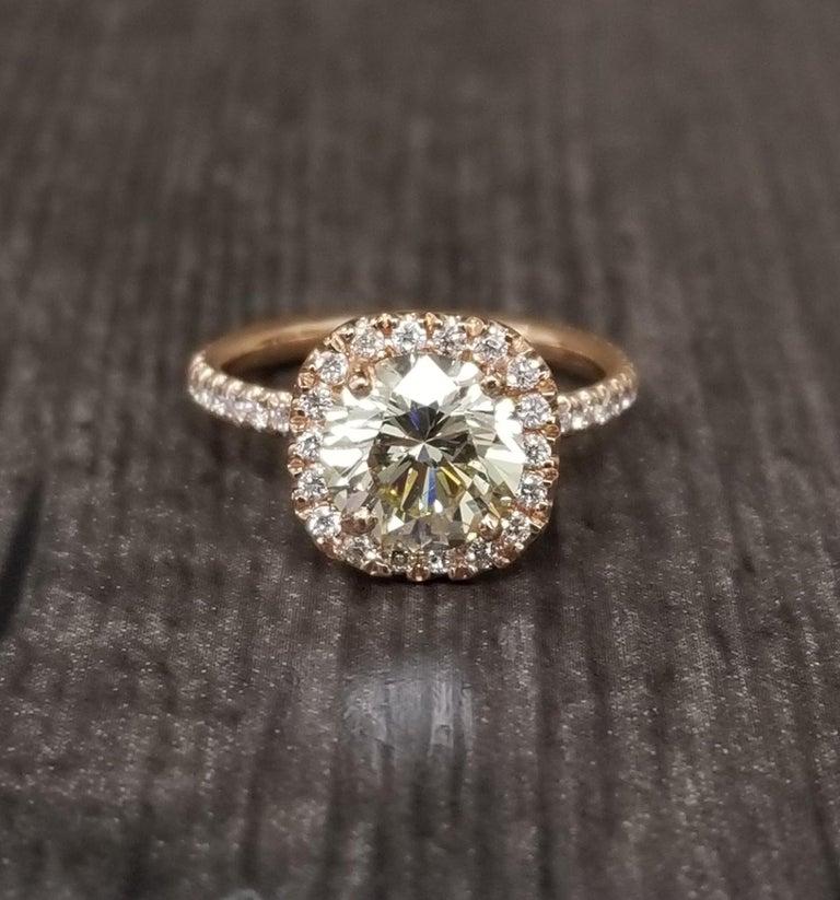 14k rose gold ladies diamond halo ring containing 1 brilliant cut diamond; color 