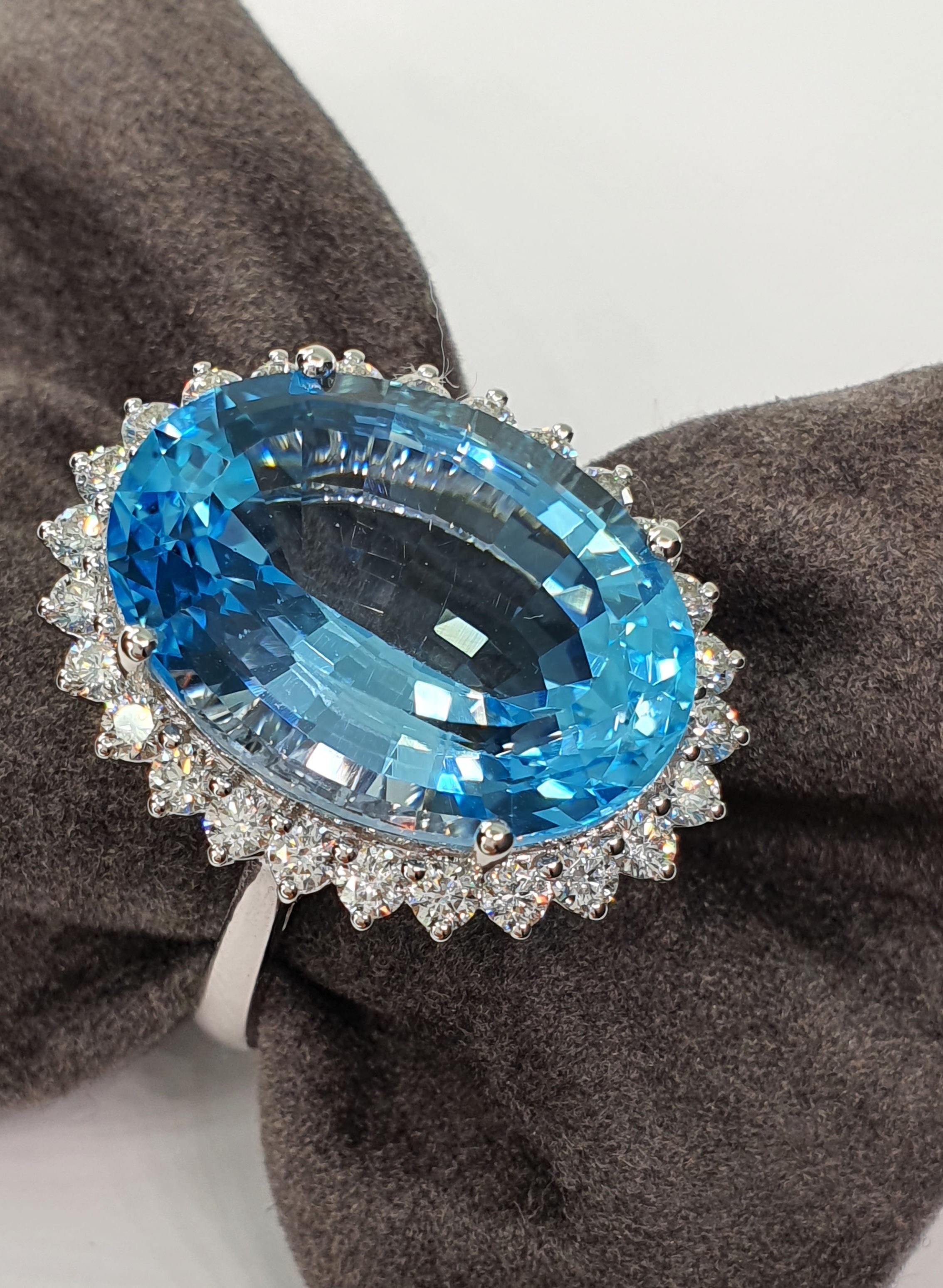 This 27.47 ctw Blue Topaz Diamond White Gold Ring is an amazing site to see! 
The gemstone cut and deep sky blue color is absolutely gorgeous!
The size and brilliance of this blue Topaz is just breathtaking ! 
There is an edge of diamonds all around