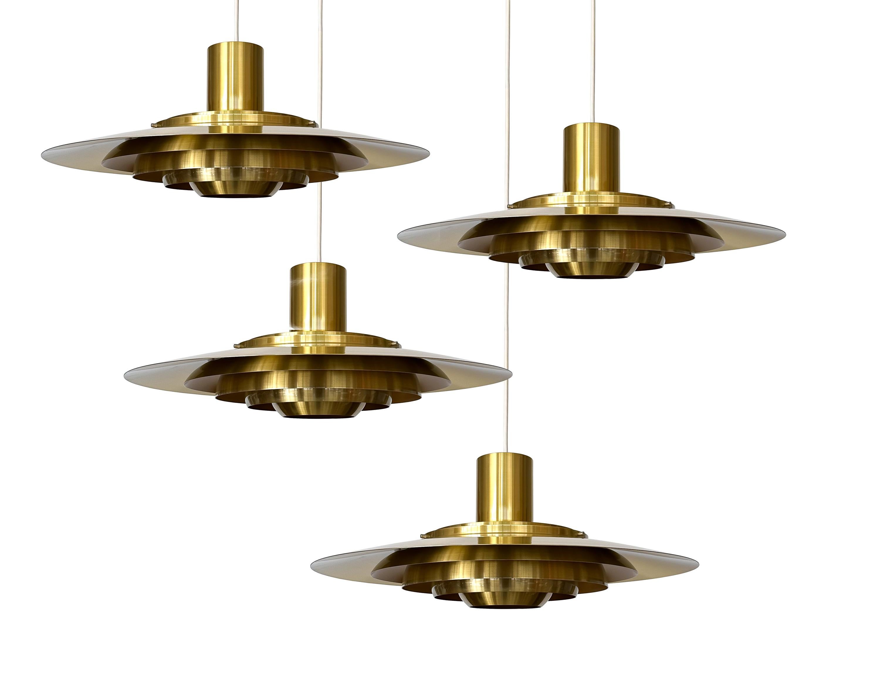 Discover the epitome of Danish sophistication with this extraordinary brass pendant chandelier, designed by the iconic design duo Preben Fabricius and Jorgen Kastholm in 1964 for Nordisk Solar, Denmark circa 1960s. Model 74407 is a grand presence