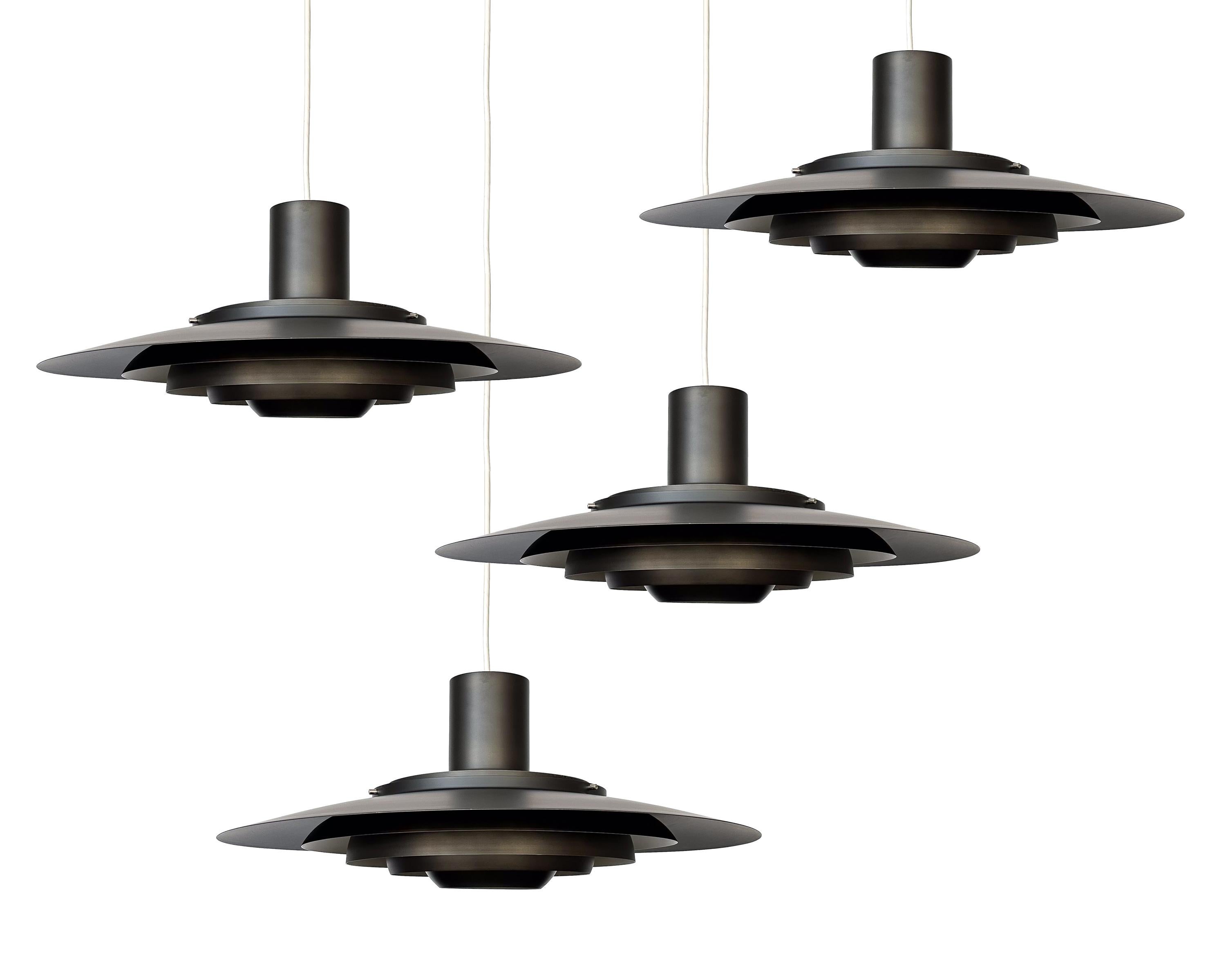 Discover the epitome of Danish sophistication with this extraordinary rare bronze pendant chandelier, designed by the iconic design duo Preben Fabricius and Jorgen Kastholm in 1964 for Nordisk Solar, Denmark circa 1960s. Model 74407 is a grand