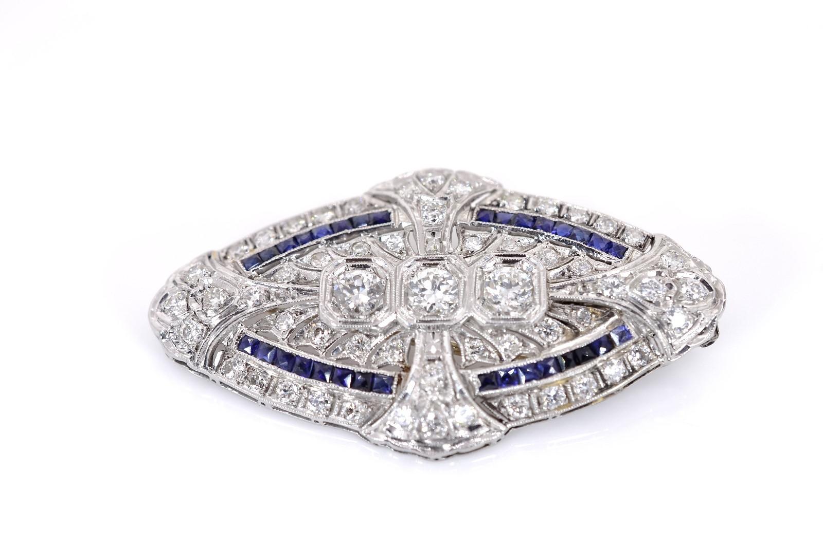 This gorgeous platinum set features a beautiful 1920's Art Deco pendant navette shape.  Set with approx. 2.75 carat of sparkling Old European cut Diamonds, and bright blue calibre French cut Ceylon Sapphire accents.  The pendant bail folds out of