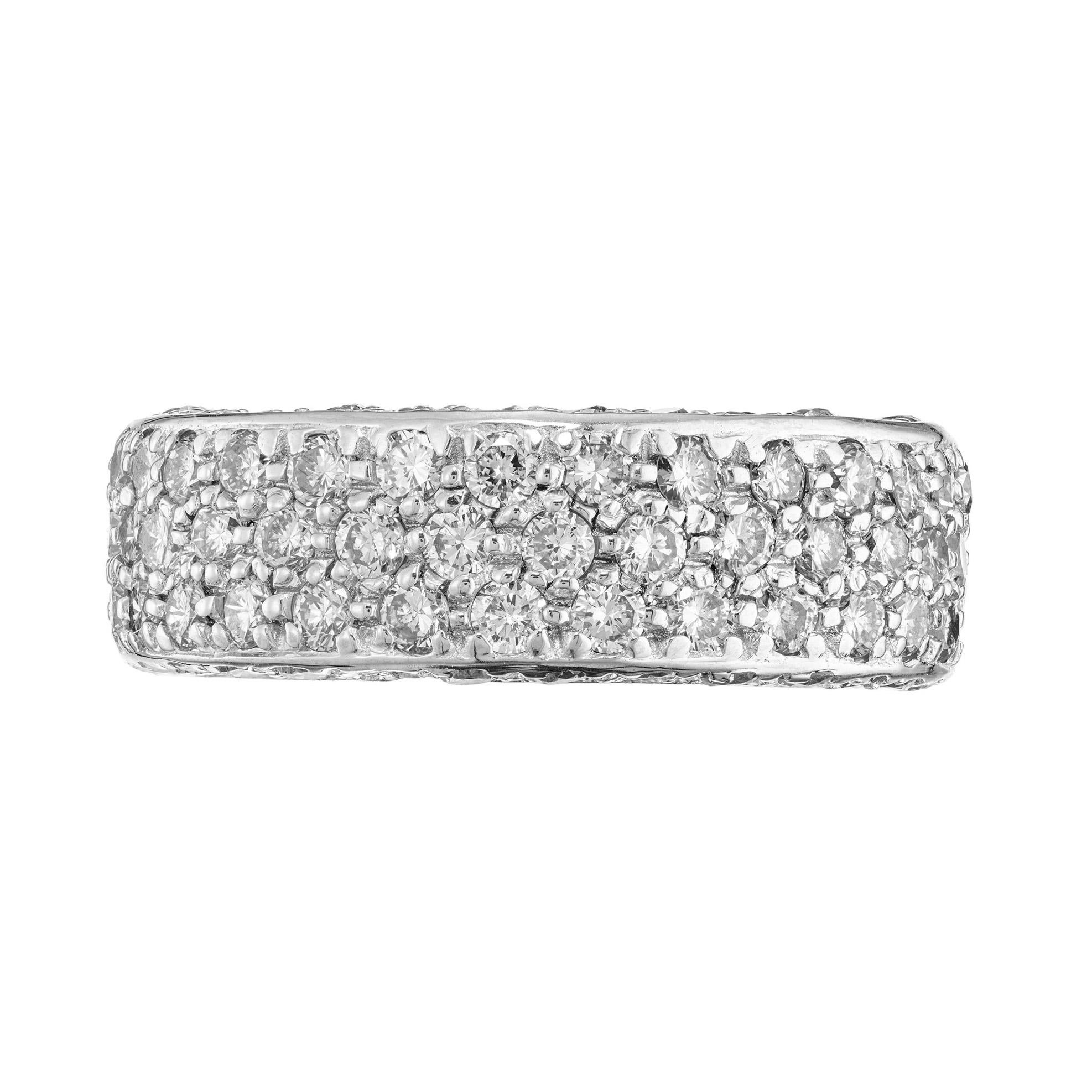 1960's 7.3 millimeters wide three row diamond pave eternity ring with both sides pave set as well. Adorned with 140 round brilliant cut diamonds with a total weight of 2.75cts. Featuring a stunning row of brilliant diamonds set in lustrous white