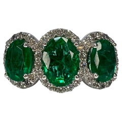 2.75 Carat Emerald Three Stone Halo Ring