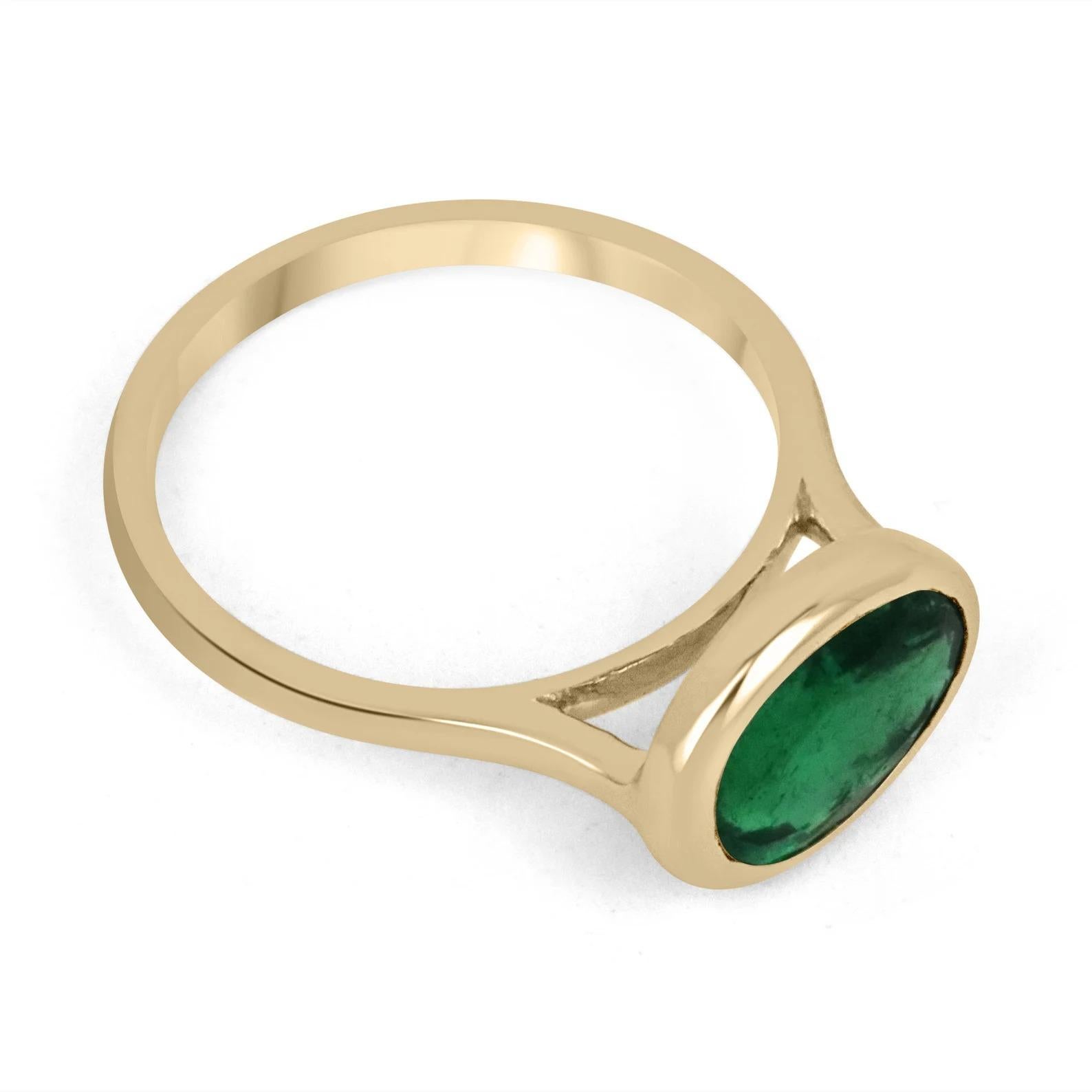 Displayed is a vivid dark forest green emerald, solitaire, oval cut bezel ring in 18K yellow gold. This gorgeous solitaire ring carries a full rare 2.75-carat emerald in a sleek bezel setting. The emerald has very good clarity and remarkable luster.