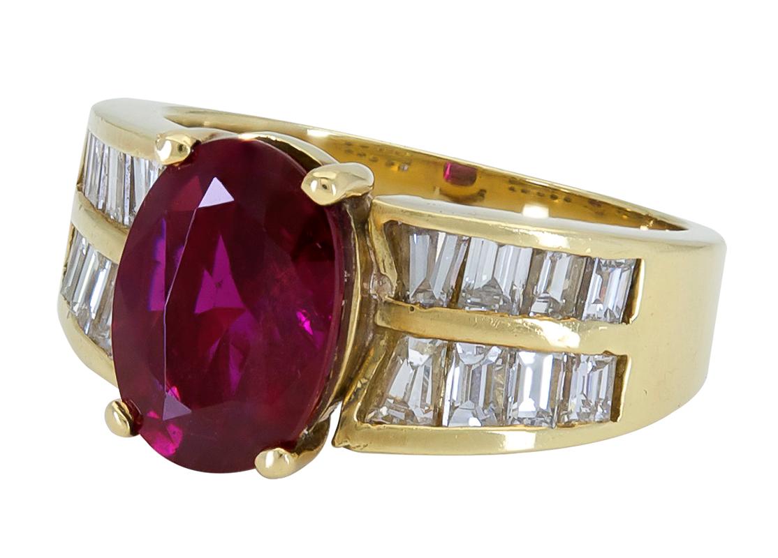 A special engagement ring showcasing a lively oval cut ruby, set an 18k yellow gold mounting accented with two rows of step-cut baguette diamonds.
Ruby weighs 2.75 carats.
Diamonds weigh 1.00 carats total.
Size 6 US (sizable)
0.39 inches length