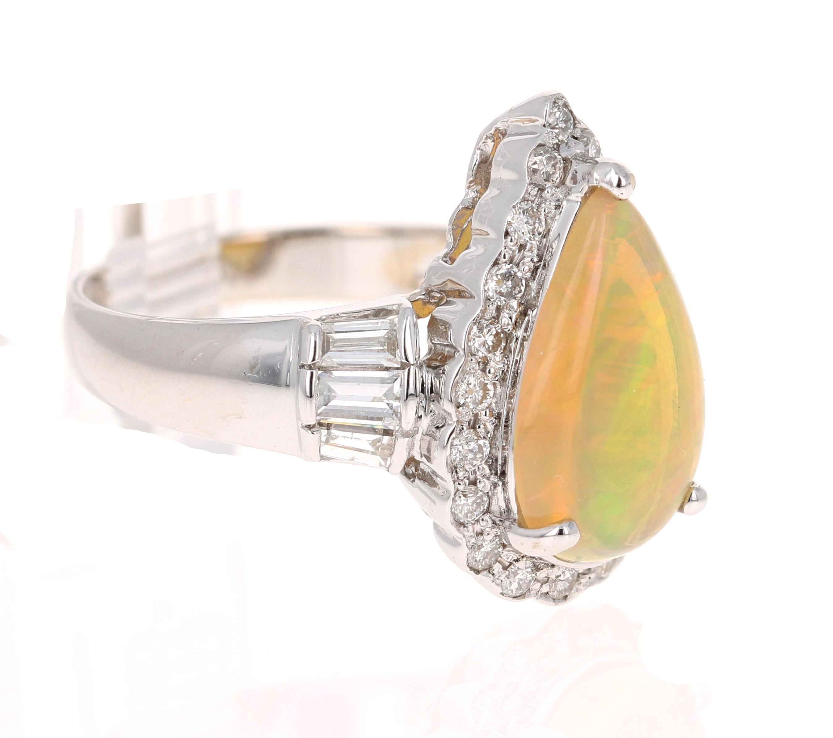 This ring has a Pear Cut Opal that is set in the center of the ring that weighs 1.92 Carats. It is surrounded by 20 Round Cut Diamonds that weigh 0.33 carats. There are also 6 Baguette Cut Diamonds that weigh 0.50 Carats. The Clarity and Color of