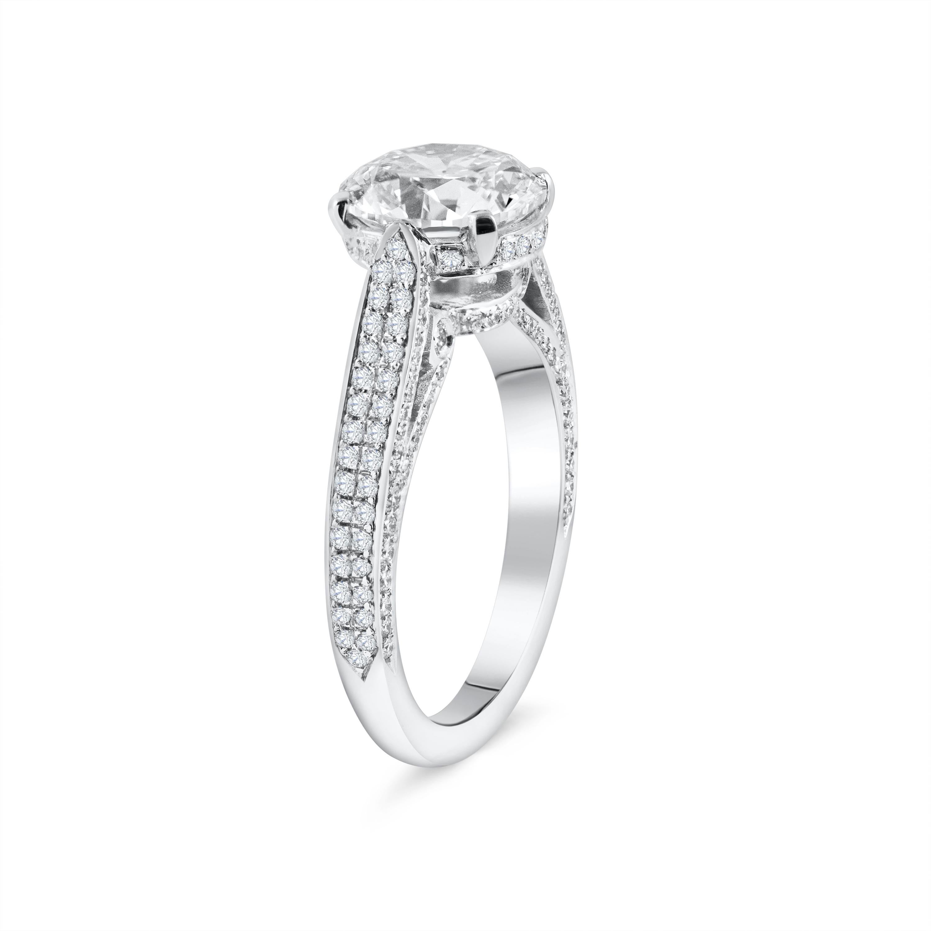 An absolutely gorgeous piece! Set with a 2.75 carats round brilliant diamond center stone in a 4 prong basket. The tapered 18k white gold composition embellished with graduating round brilliant diamonds that goes half-way down the shank of the ring.
