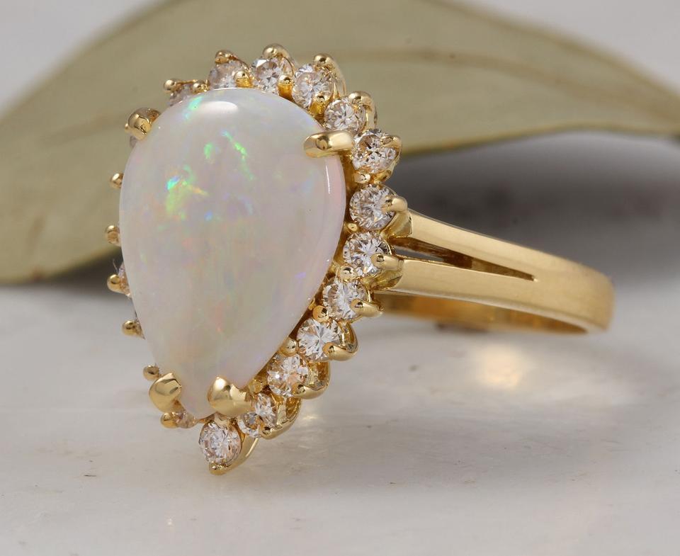 2.75 Carats Natural Impressive Ethiopian Opal and Diamond 14K Solid Yellow Gold Ring

Total Natural Opal Weight: 2.30 Carats

Opal Measures: 13.5 x 10.1mm

Natural Round Diamonds Weight: .45 Carats (color G-H / Clarity SI1-SI2)

Ring size: 7 (we