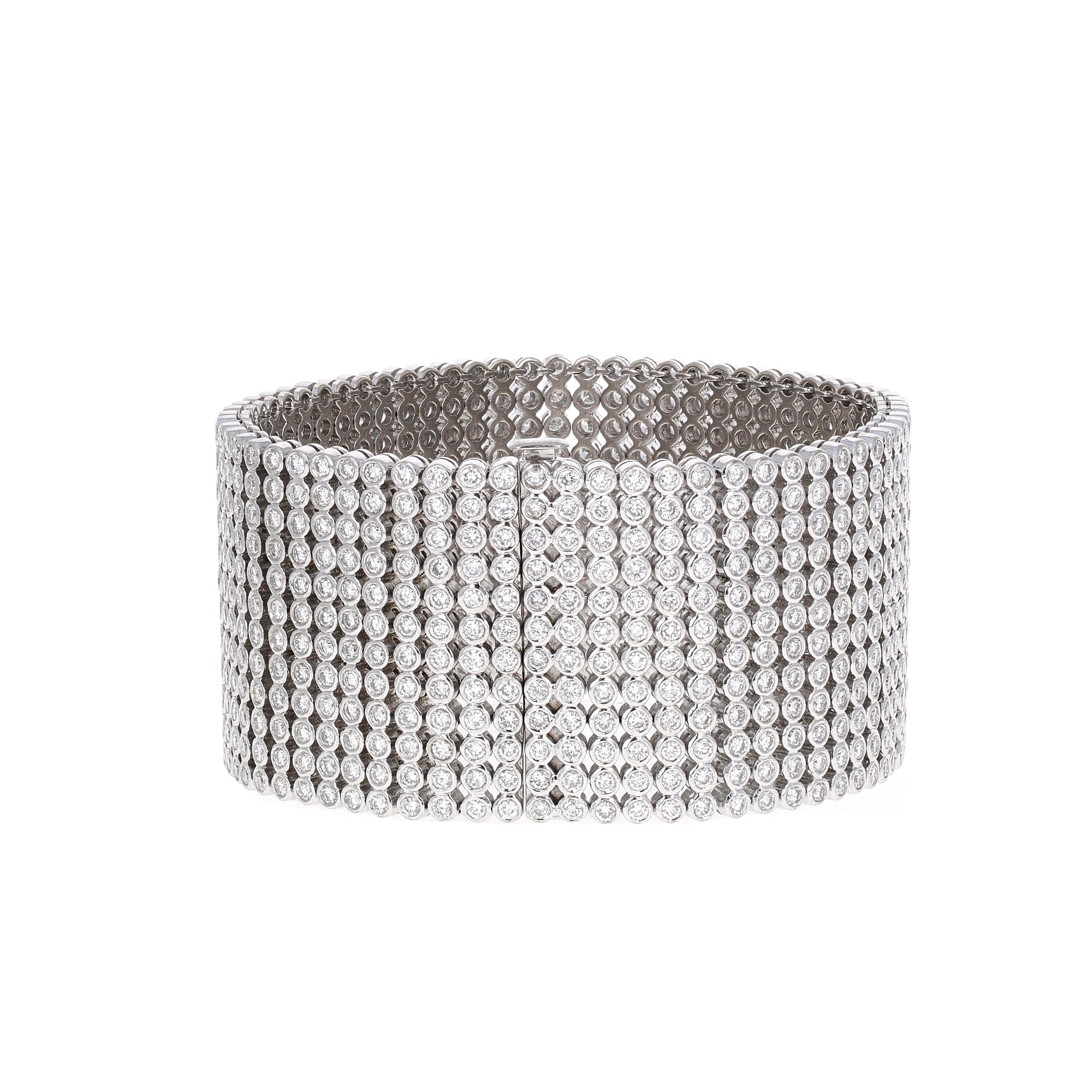 18k white gold 27.50-carat wide diamond tennis bracelet cuff.  The diamonds are round brilliant cut G-H color and VS- SI clarity. Each of the 744 diamonds are bezel set, making the movement and fluidity of this bracelet perfect.
The 744 diamonds