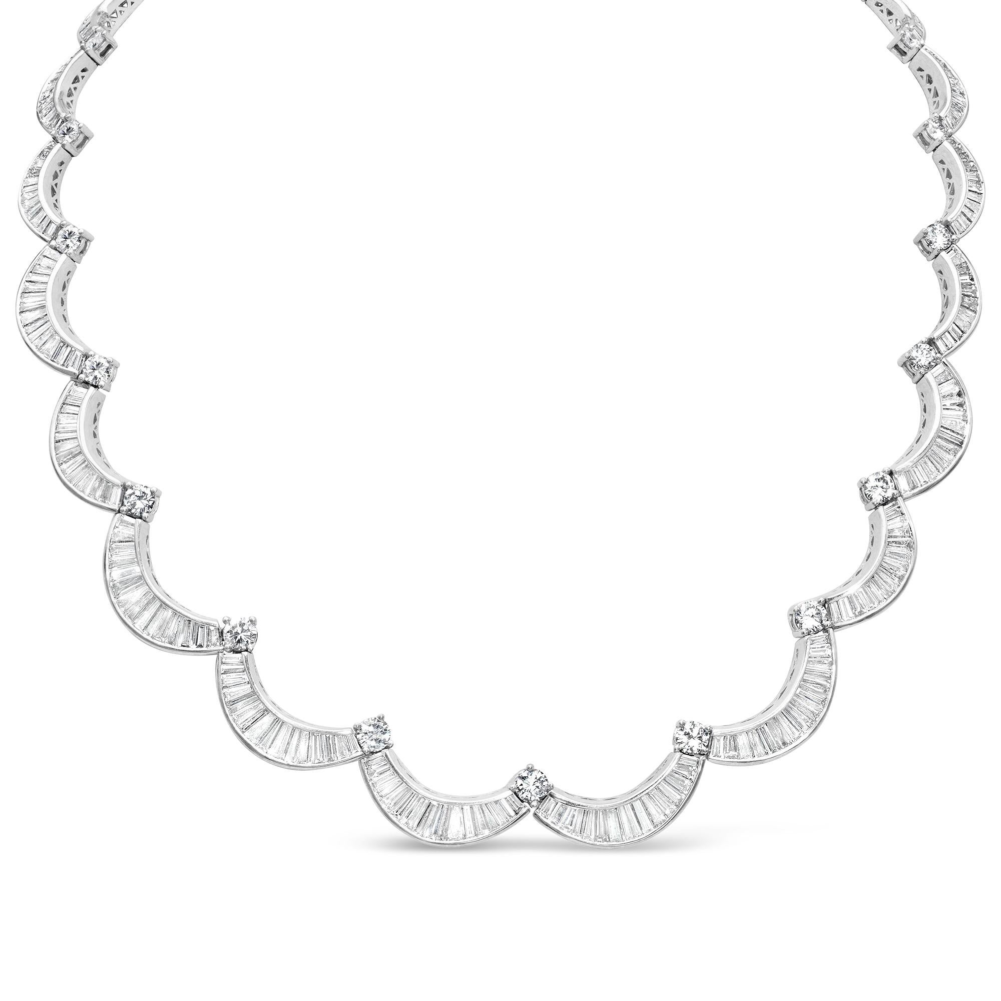 Elegante collana con diamanti graduali taglio baguette per un totale di 23,00 carati, incastonati in un design curvo. Accentuato da diamanti rotondi taglio brillante che si trovano all'estremità di ogni curva, per un peso totale di 4,50 carati. I