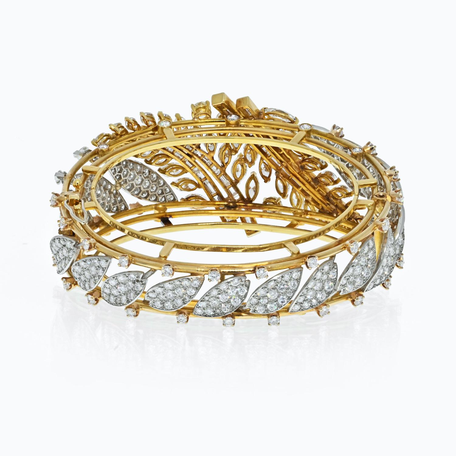 This diamond bangle bracelet is made to dazzle and will captivate you with its artful design. The bracelet is lavished with 27.50cttw of glorious diamonds, sparkling brilliantly from a band crafted in 18K Gold and Platinum. Notice how the