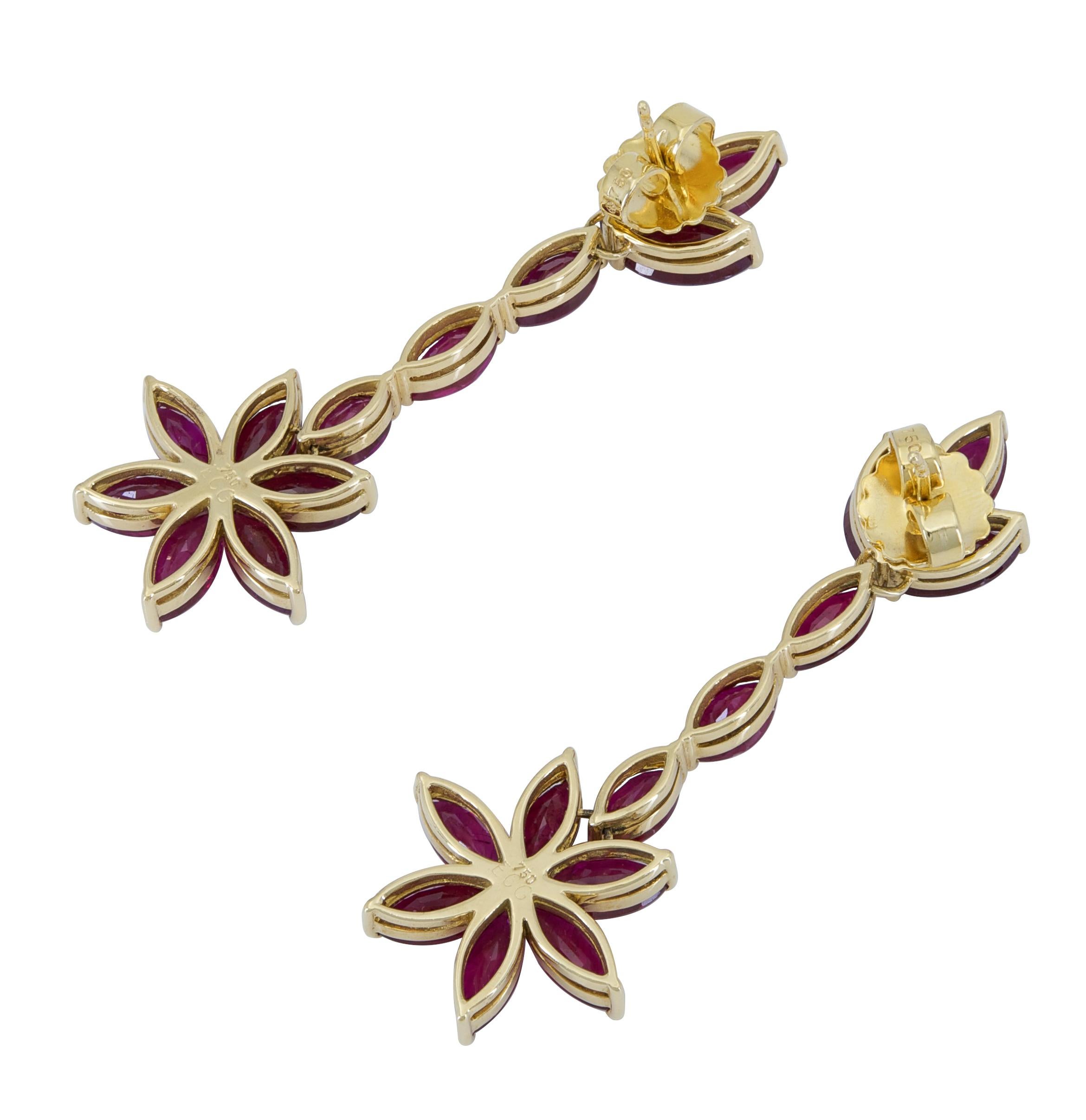 A fashionable pair of dangle earrings showcasing marquise cut rubies arranged in a chic flower design. Suspended on a row of marquise rubies set in 18k yellow gold. 
Rubies weigh 27.51 carats total.
Dimensions: 5.90cm (L) x 2.10cm (W)
Creator: Ely