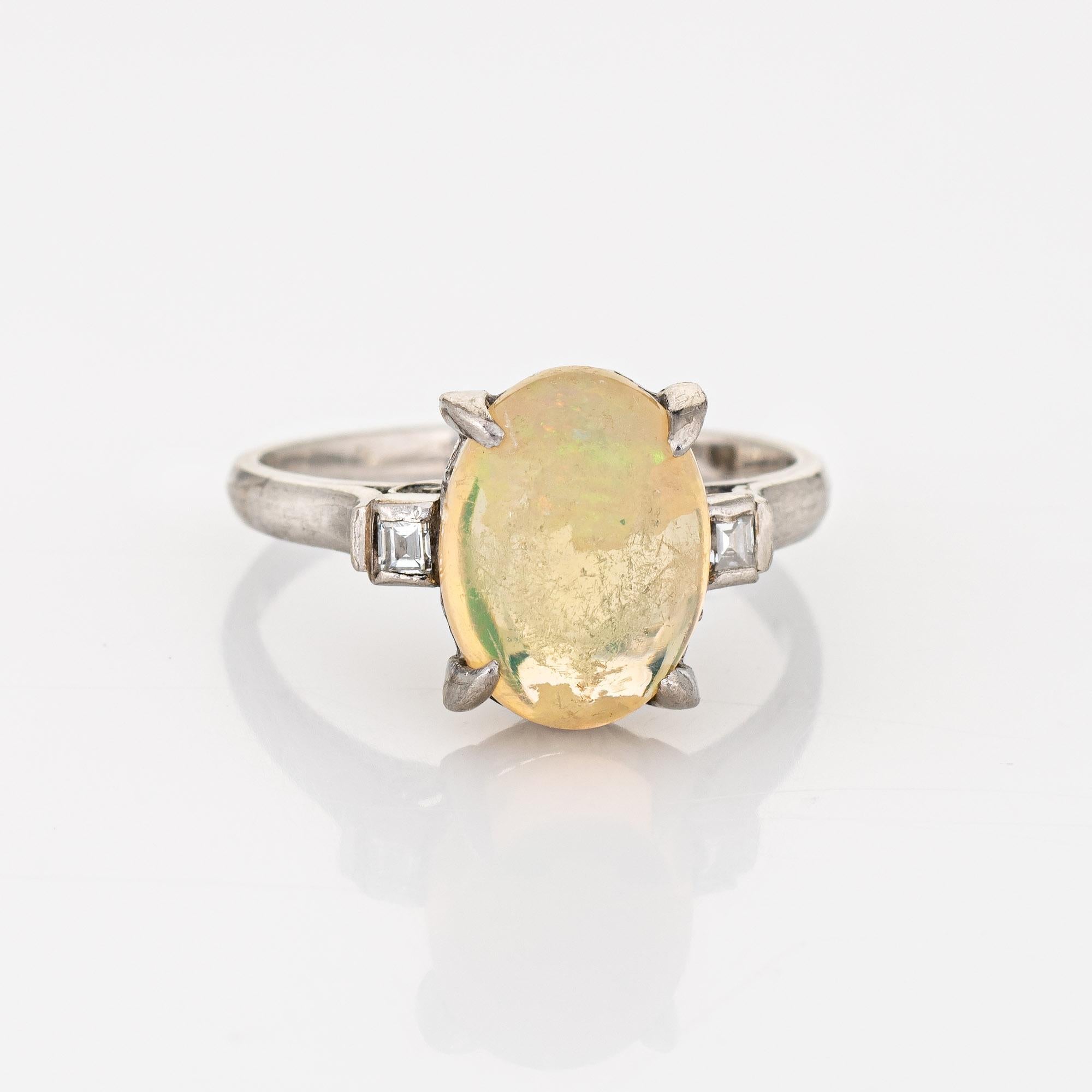 Stylish natural jelly opal & diamond cocktail ring crafted in 900 platinum. 

Cabochon cut natural jelly opal, 2.75 carats (11 x 8.5mm). The opal is in very good condition and free of cracks or chips (light surface abrasions from normal wear evident