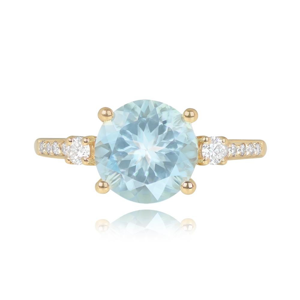 This ring showcases a 2.75-carat round aquamarine set in prongs. It is elegantly adorned with round brilliant cut diamonds, flanking the aquamarine and gracing the shoulders. The combined diamond weight of this exquisite piece is around 0.24 carats.