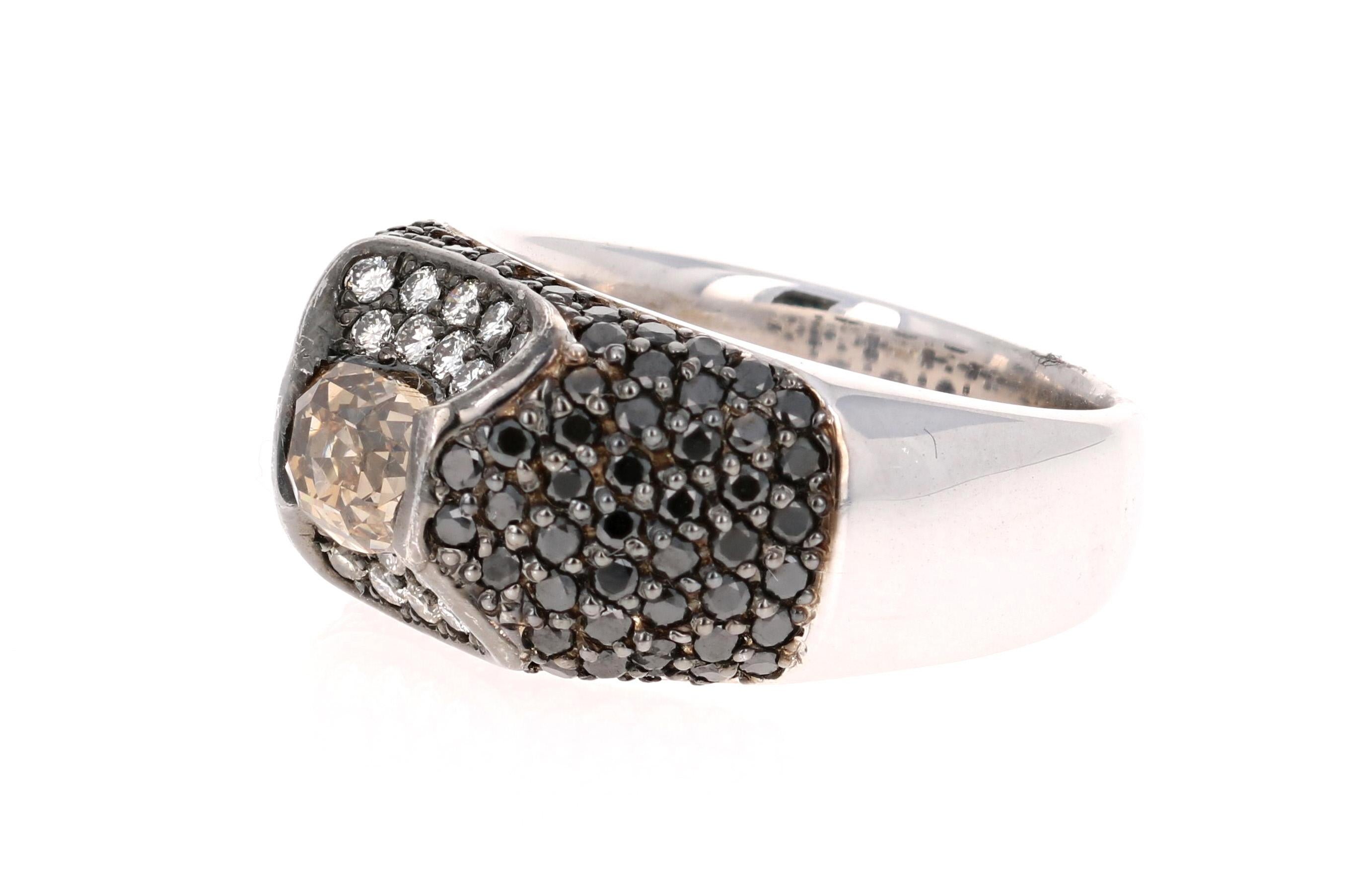 A unique Black Diamond and Natural Fancy-Colored Diamond ring.  This ring has 1 Oval Cut Natural Fancy-Colored Diamond floating in the center of the ring that weighs 1.27 carats and is surrounded by 18 Round Cut Diamonds that weigh 0.31 carats and