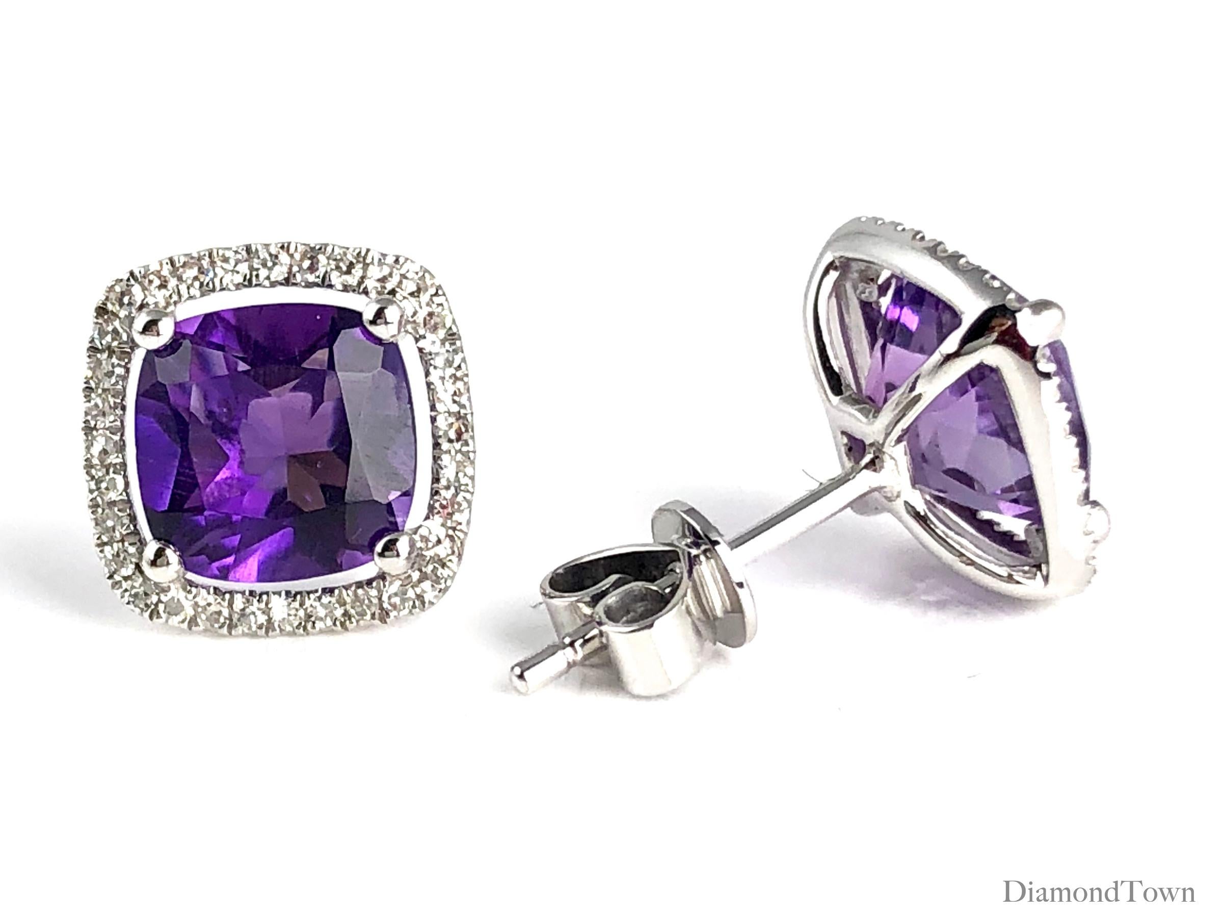These stunning halo stud earrings feature 2.76 carats Fine Amethyst, surrounded by a halo of round white diamonds.

Center: two cushion cut Fine Amethyst stones total 2.76 carats
Diamond Halo: 64 round diamonds total 0.18 carats
Set in 14k White