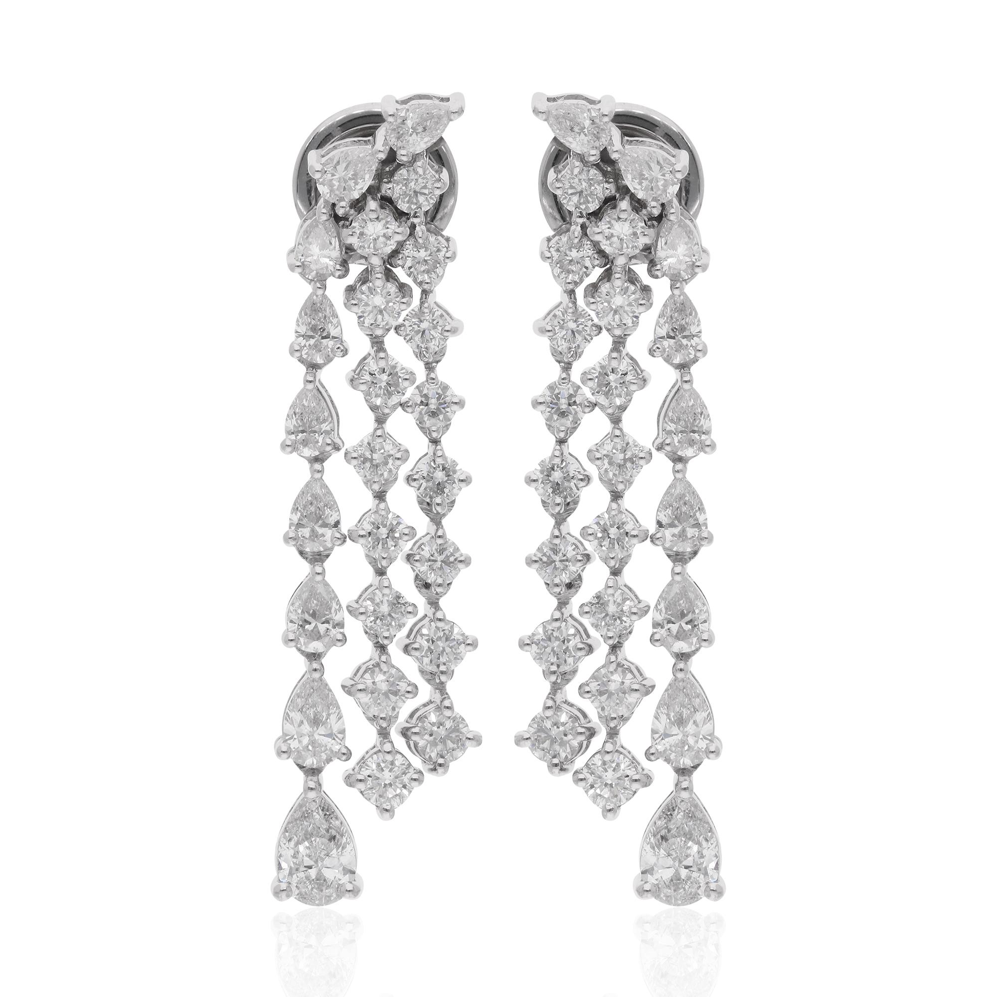 These exquisite chandelier earrings are crafted in 14 karat white gold and feature a captivating combination of pear-shaped and round diamonds with a total carat weight of 2.76 carats. The pear-shaped diamonds, known for their elegant and elongated