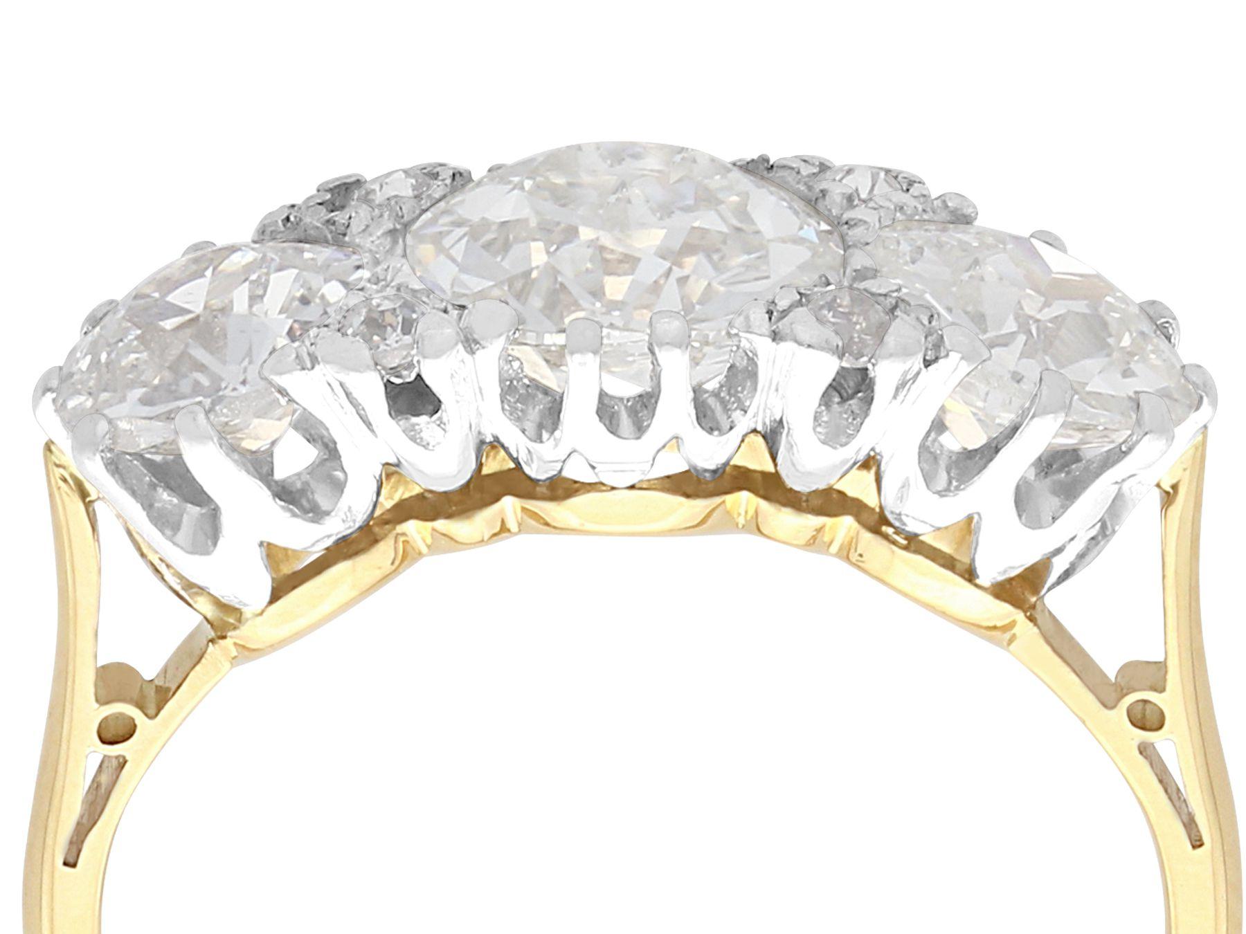 A stunning, fine and impressive vintage 2.76 carat diamond, 18 karat yellow gold and platinum trilogy ring; part of our diverse vintage diamond jewelry collections

This stunning, fine and impressive vintage trilogy ring has been crafted in 18k
