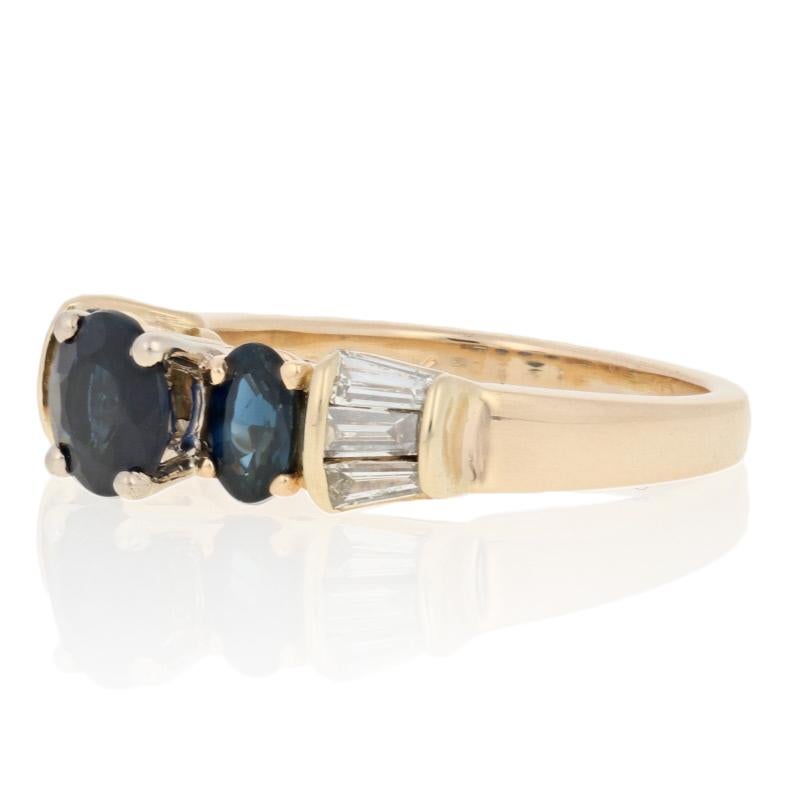 This ring is a size 5 1/2.

Metal Content: Guaranteed 14k Gold as stamped (yellow and white)

Stone Information: 
Genuine Sapphires
Treatment: Heating 
Color: Blue
Cuts: Round & Oval  
Solitaire's Diameter: 5.9mm
Carats: 2.40ctw

Natural Diamonds 