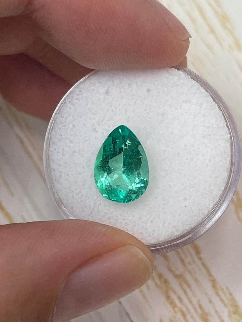 Stone: Emerald
Weight: 2.77-carats
Shape: Pear Cut
Clarity: Transparent
Luster: Very Good
Color: Medium Yellowish Green
Measurements: 11.42mm x 8.11mm x 5.86mm
Geographic Origin: Colombia
Treatment: Natural, Oiling

Comments: Due to their growth