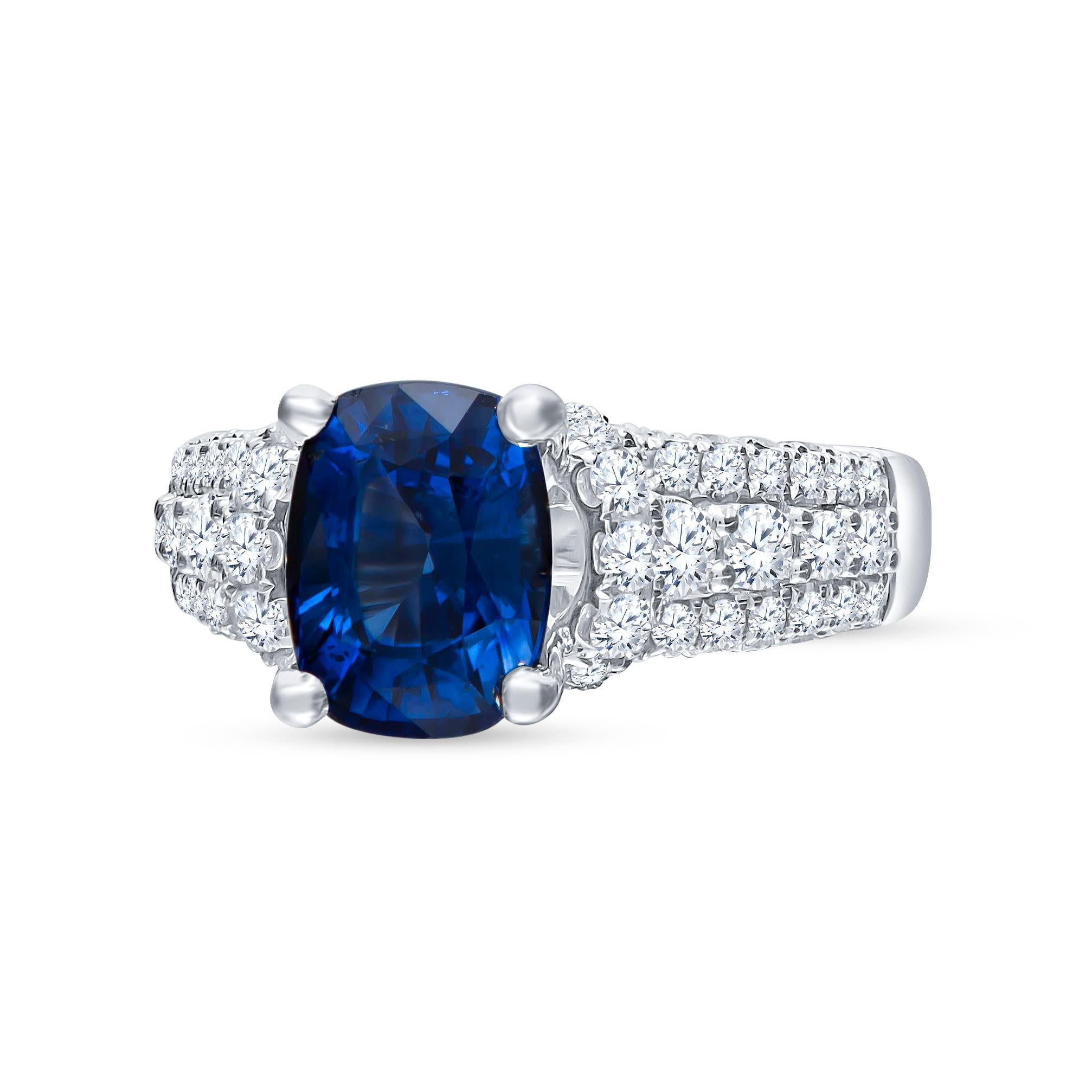 Beautifully placed 2.77 carat cushion cut natural blue sapphire (GIA Certified) centered in a 3-Row diamond band going halfway. The ring is made into a size 5 and may be resized to larger or smaller upon request. 

Diamond Quality: F-G color,