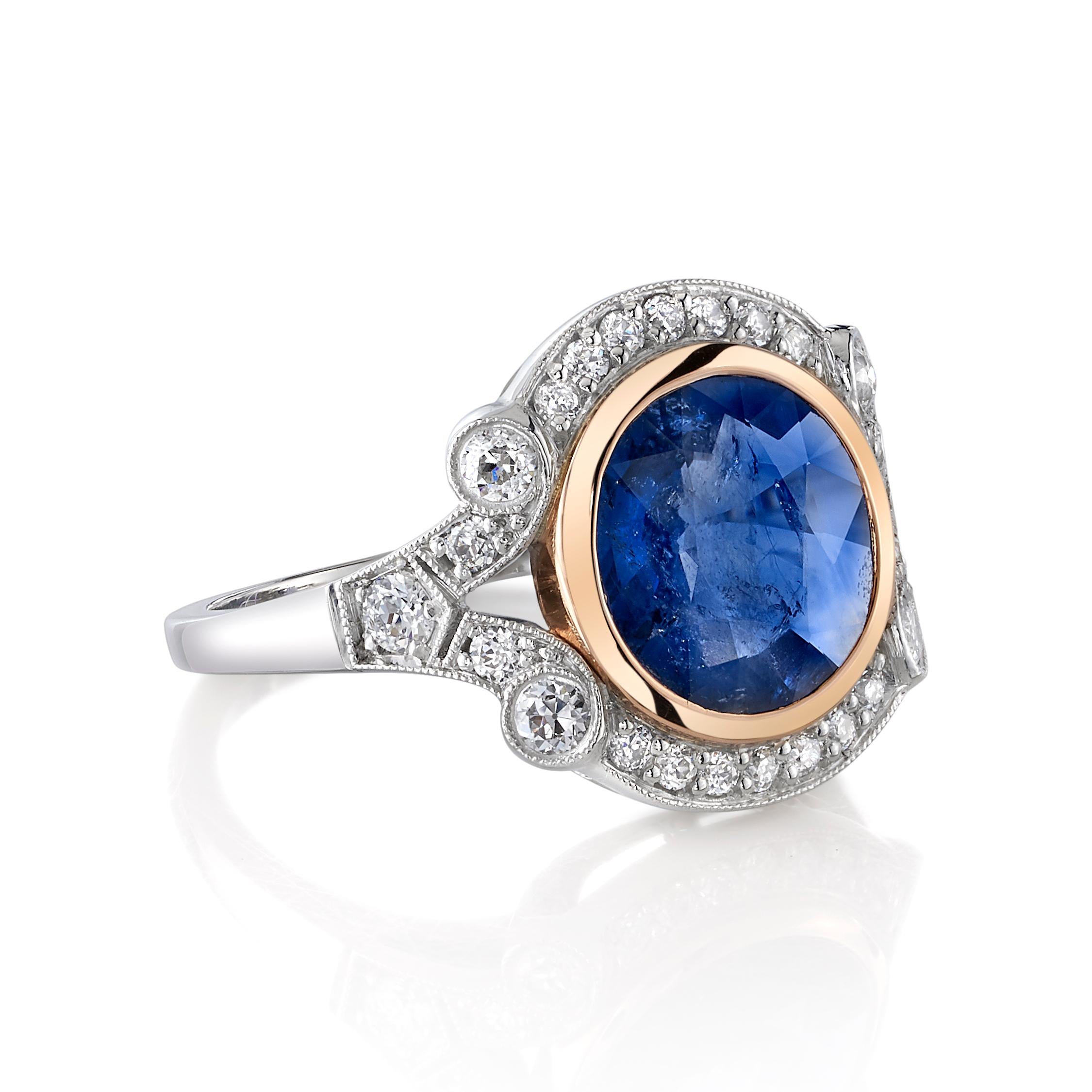 2.77ctw Round cut blue sapphire set in a handcrafted platinum and 18K rose gold mounting. 0.50ctw old European cut accent diamonds set in scrolling platinum surround this deep blue sapphire.

Ring is currently a size 6 and can be sized to fit. 