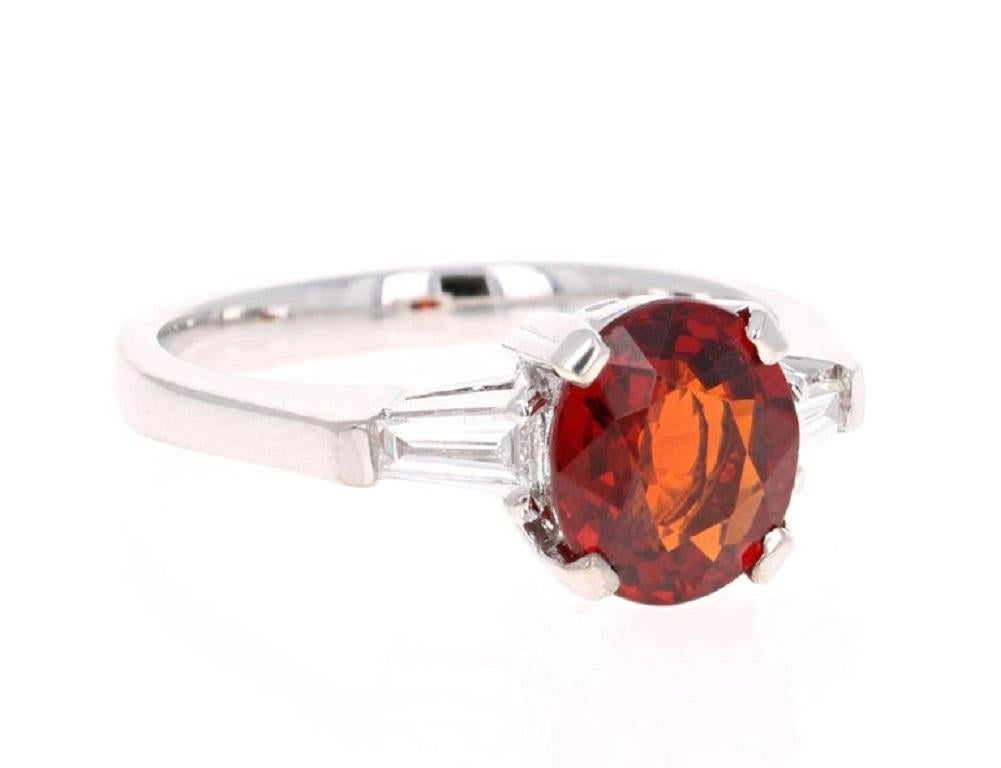 A simple and cute ring that can also be a unique engagement ring.  This beautiful ring has a 2.52 Carat Oval Cut Spessartine. A Spessartine is a natural stone that is a part of the Garnet family of stones. 
It is embellished with 2 Baguette Cut