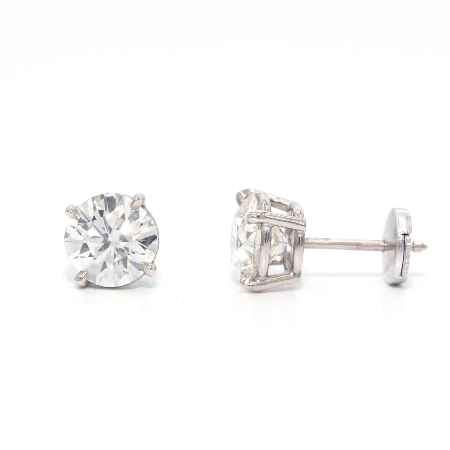 These natural diamond stud earrings are classic and a must have.
1.41 carat and 1.36 carat round diamonds, with k color and vs clarity. full of brilliance and sparkle, set in a luxurious 14 karat white gold martini setting.

An outstanding gift for