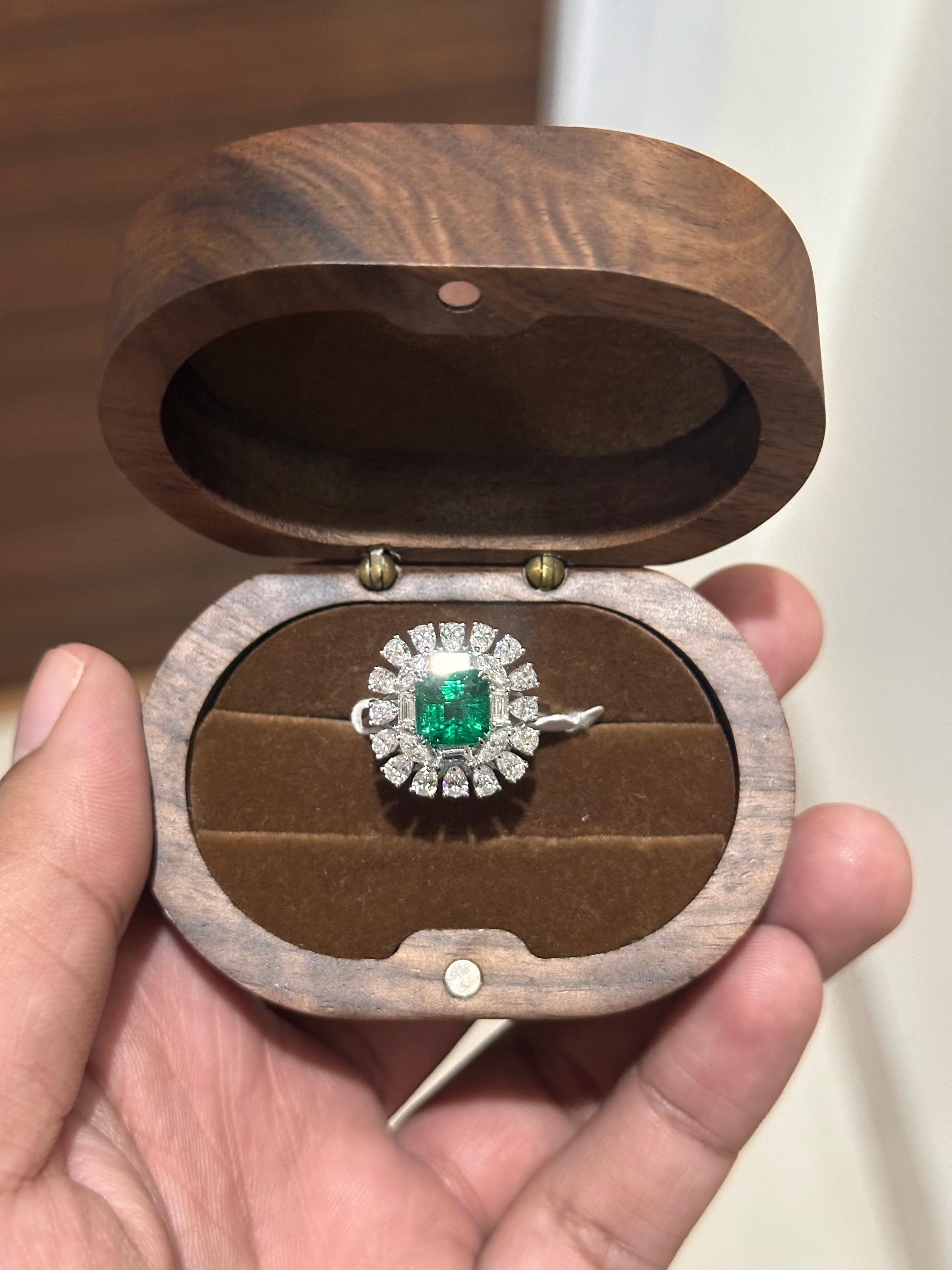 Elegant and timeless, this striking ring showcases a 2.77 carat natural Zambian emerald, celebrated for its vivid green color and exceptional transparency. The emerald, cut in a bold emerald shape, has undergone minor oil treatment — a gentle,