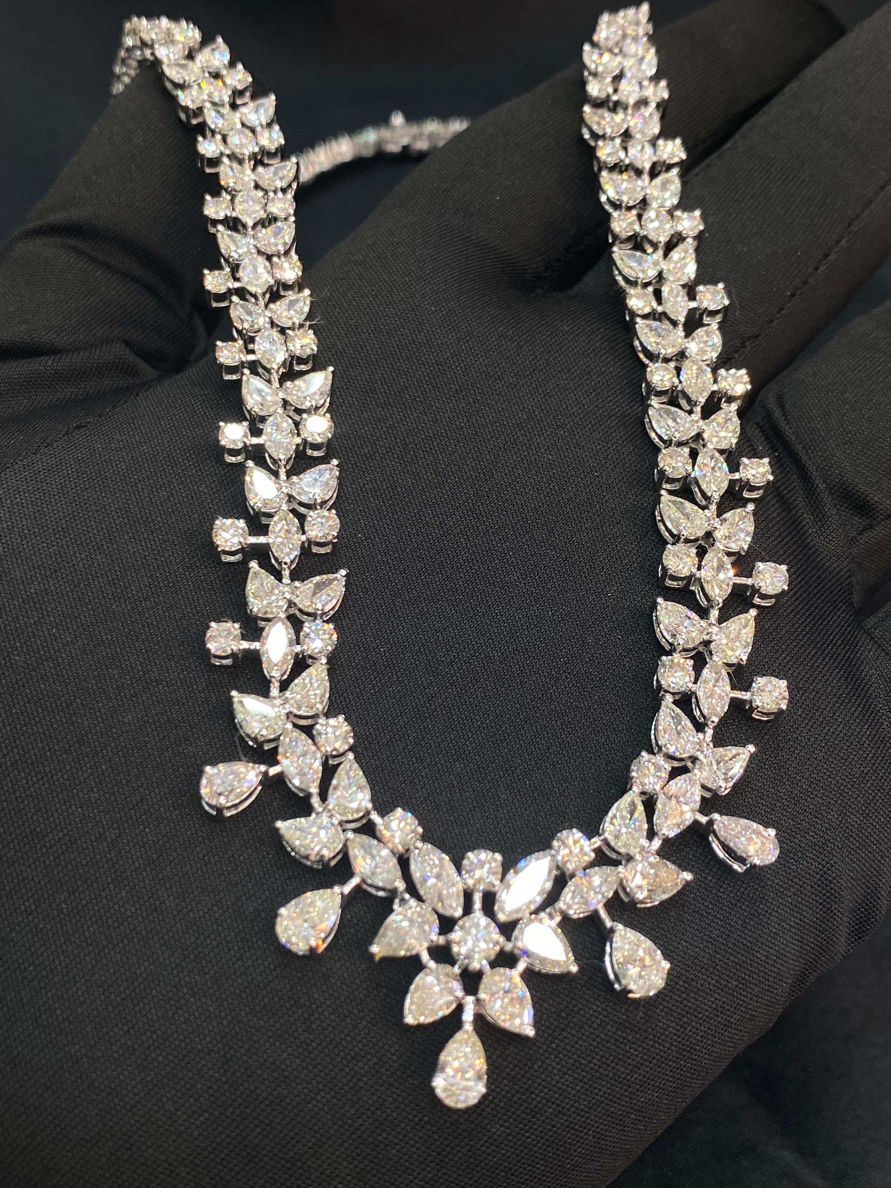This exquisite necklace showcases 27.76 carats of marquise, pear, and round shape natural diamonds set in 18K white gold. Its captivating design makes it an ideal choice to dazzle on any wedding day, drawing attention with its elegance and