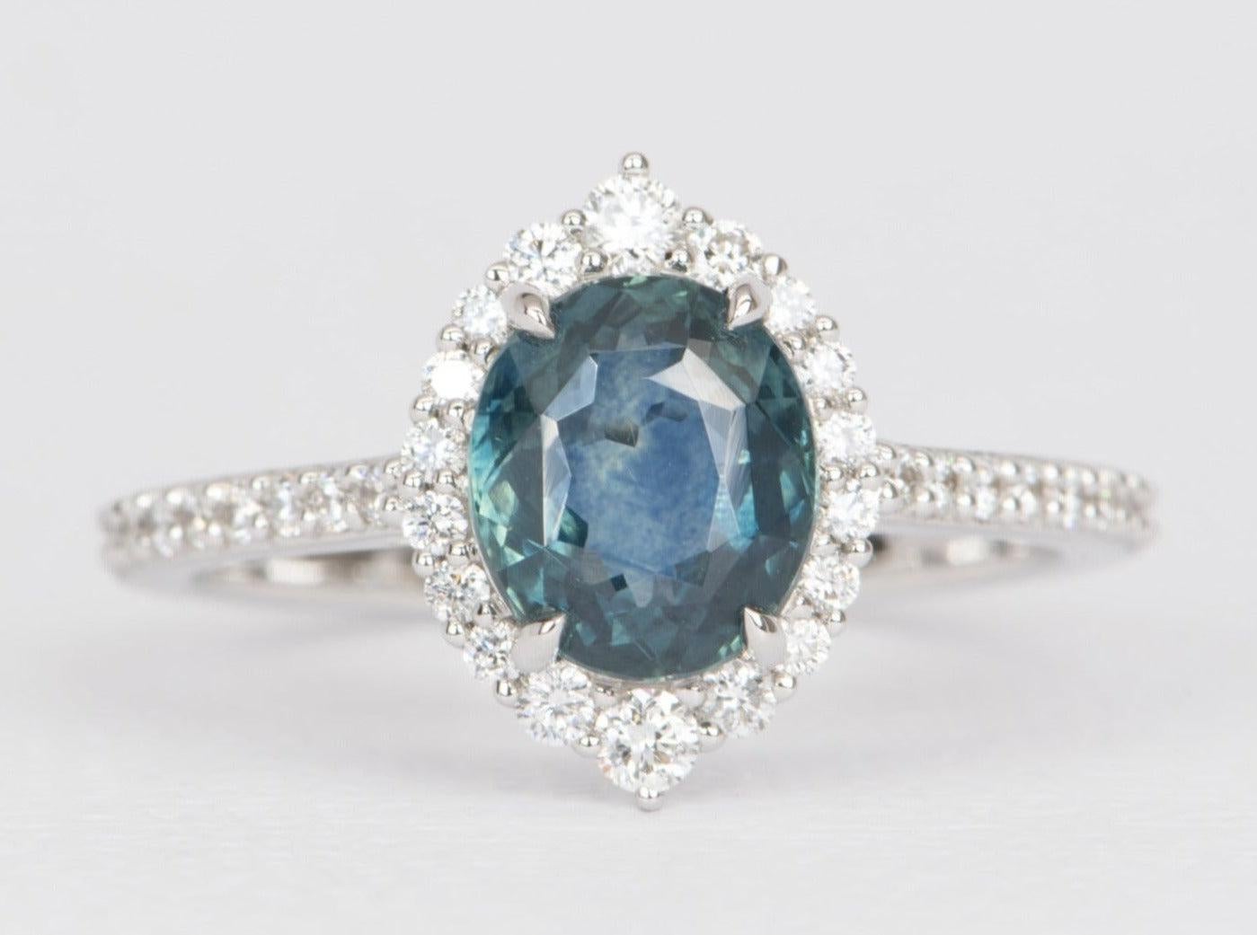 ♥ 1.41ct Montana Sapphire with Diamond Halo and Pave Band 14K White Gold Engagement Ring
♥ Solid 14k white gold ring set with a beautiful oval-shaped montana sapphire
♥ Gorgeous blue green color!
♥ The item measures 12 mm in length, 8.6 mm in width,