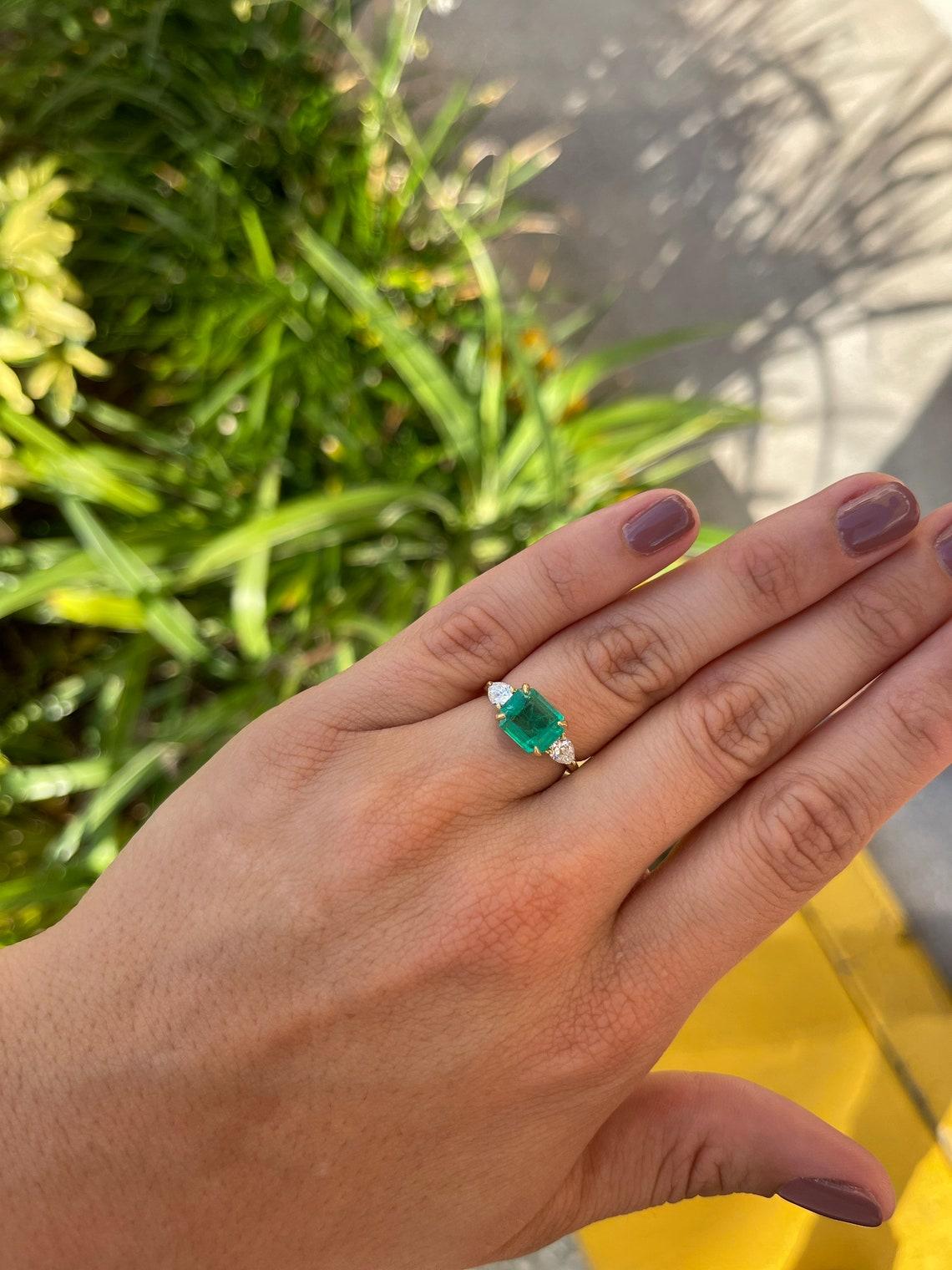 emerald cut and pear cut ring