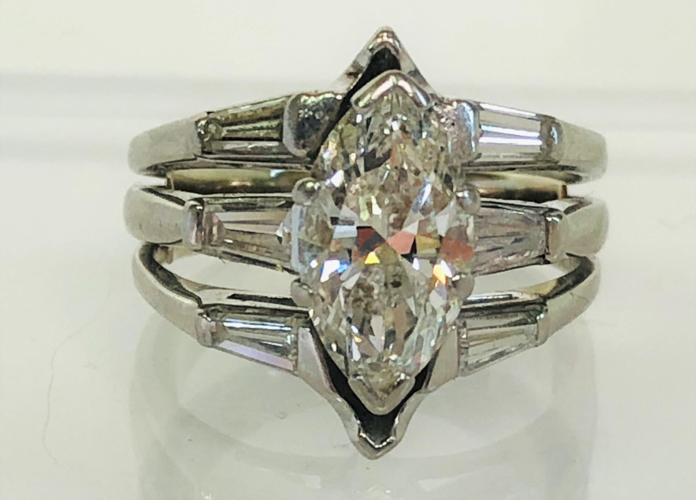 This ring sparkles from across the room!
Center marquise cut diamond approximately 2.33ct, I-J color, SI clarity
Six tapered baguette diamonds, approximately .11ct each.  One baguette has small chip
Size 6 (with inner horseshoe shank).
Platinum