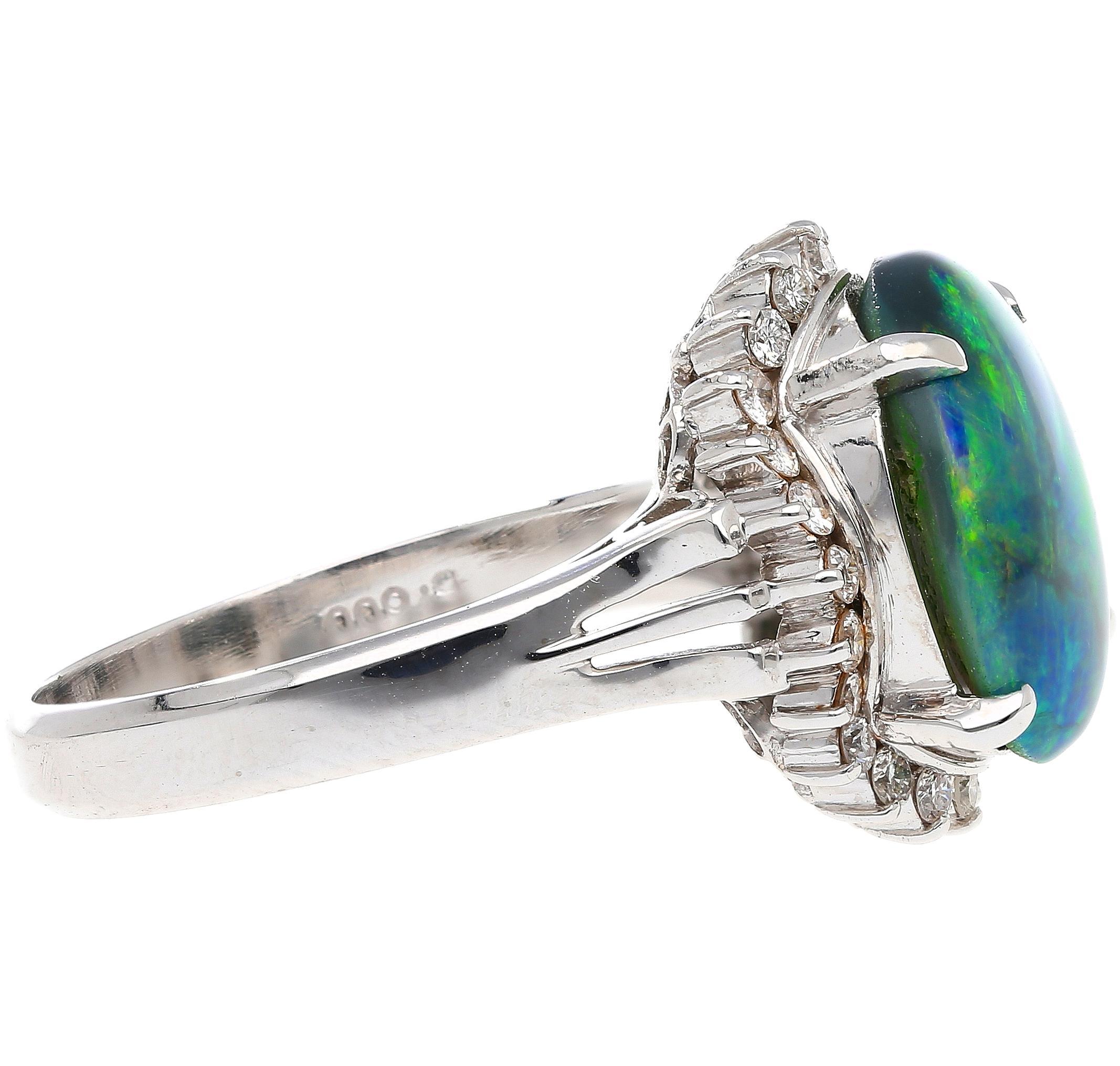 2.78 carat natural black opal and round cut diamond halo ring. Set in a smooth textured platinum 900 ring setting. The center stone bears a rich, vibrant color pattern that radiated different hues depending on how the ring is worn. A true spectacle