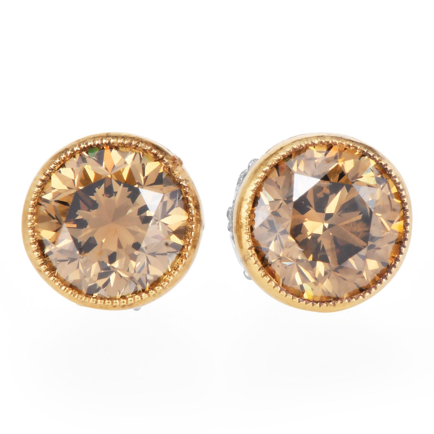 A rich, warm take on classic studs, these exquisite earrings feature 2.03 carats of natural brown-yellow diamonds VS clarity, beautifully bezel-set in platinum and 18K yellow gold. The deep mocha hue is accentuated by 0.30 carats of brilliant round