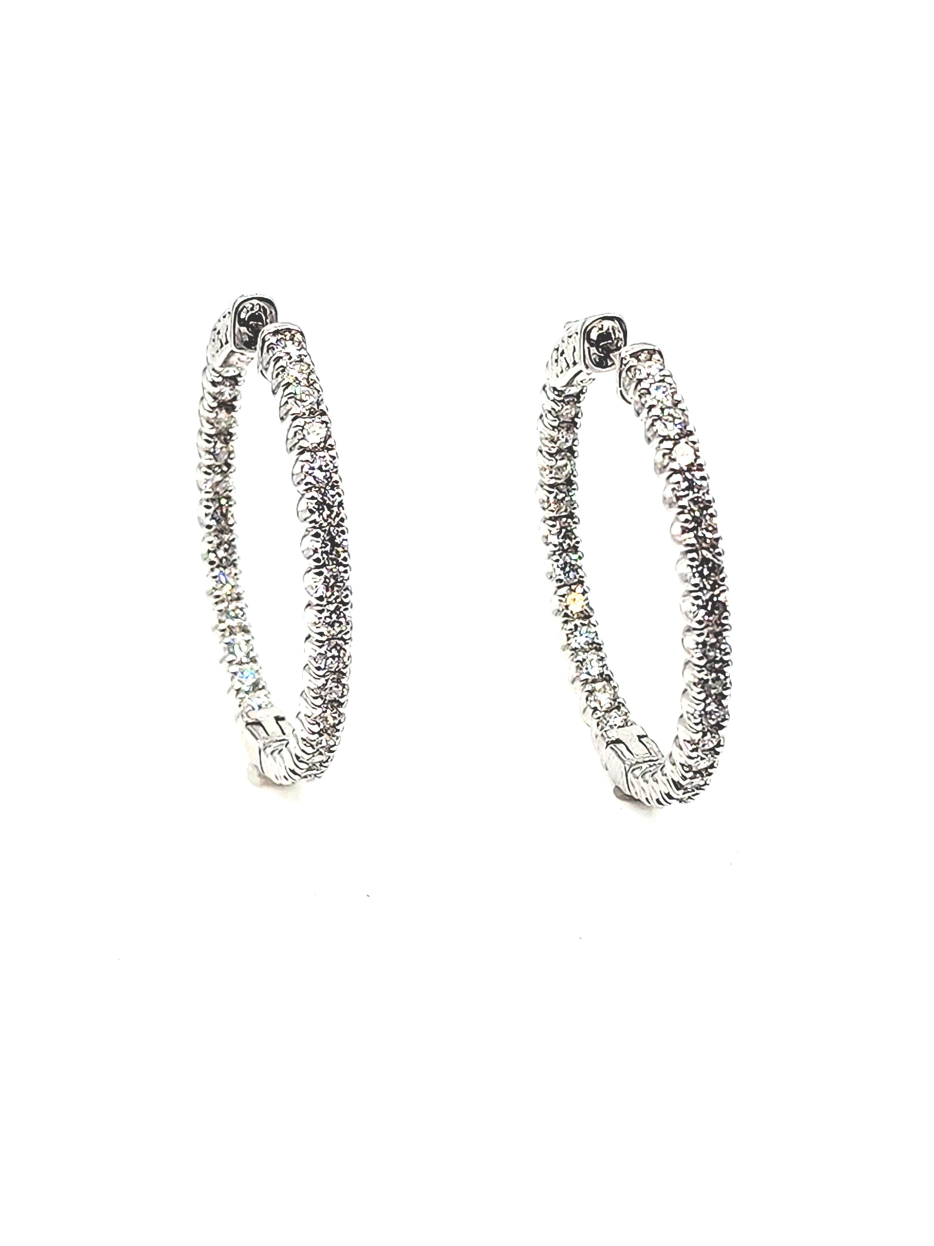 14k white gold diamond in and out hoop earrings feature 60 diamonds weighing 2.78 cts graded F-G, VS2-SI1 set in 14k white gold.