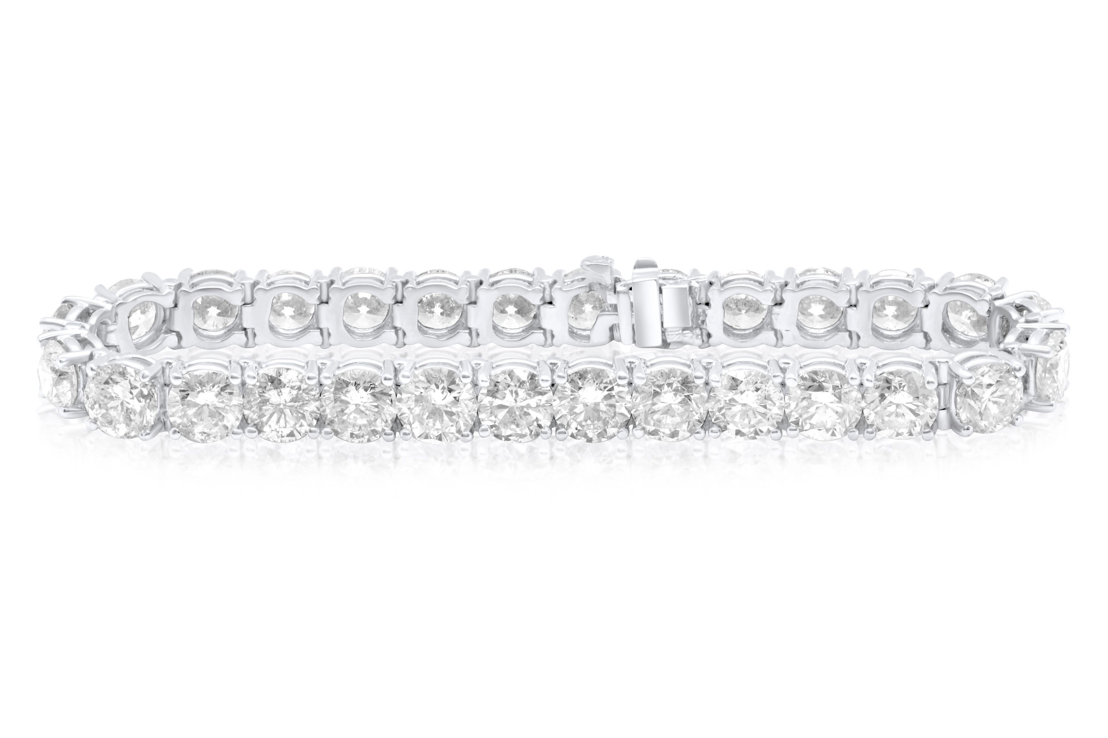 18K White Gold diamond tennis bracelet, set in a classic four prong diamond mounting. 
Total diamond weight is 27.87 Carats of Ideal Brilliant Cut Diamonds. 
Near colorless white in color, slightly included