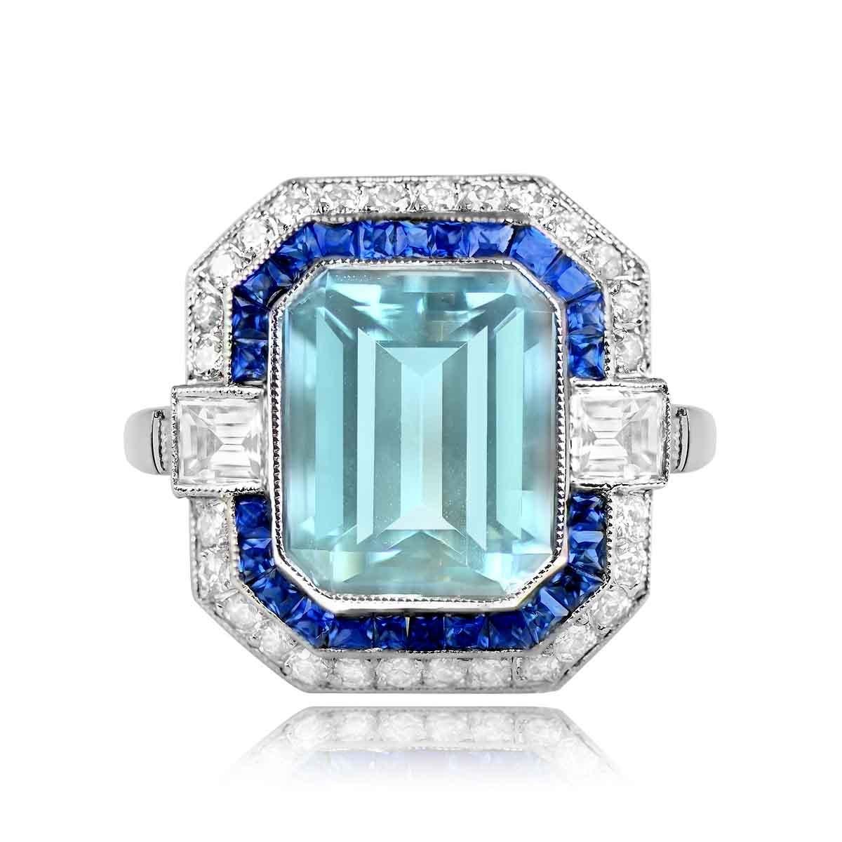 A breathtaking geometric gemstone ring showcasing a natural emerald-cut aquamarine weighing approximately 2.78 carats. The center stone is accented by a double halo of old European cut diamonds and natural French-cut blue sapphires. Two carre-cut
