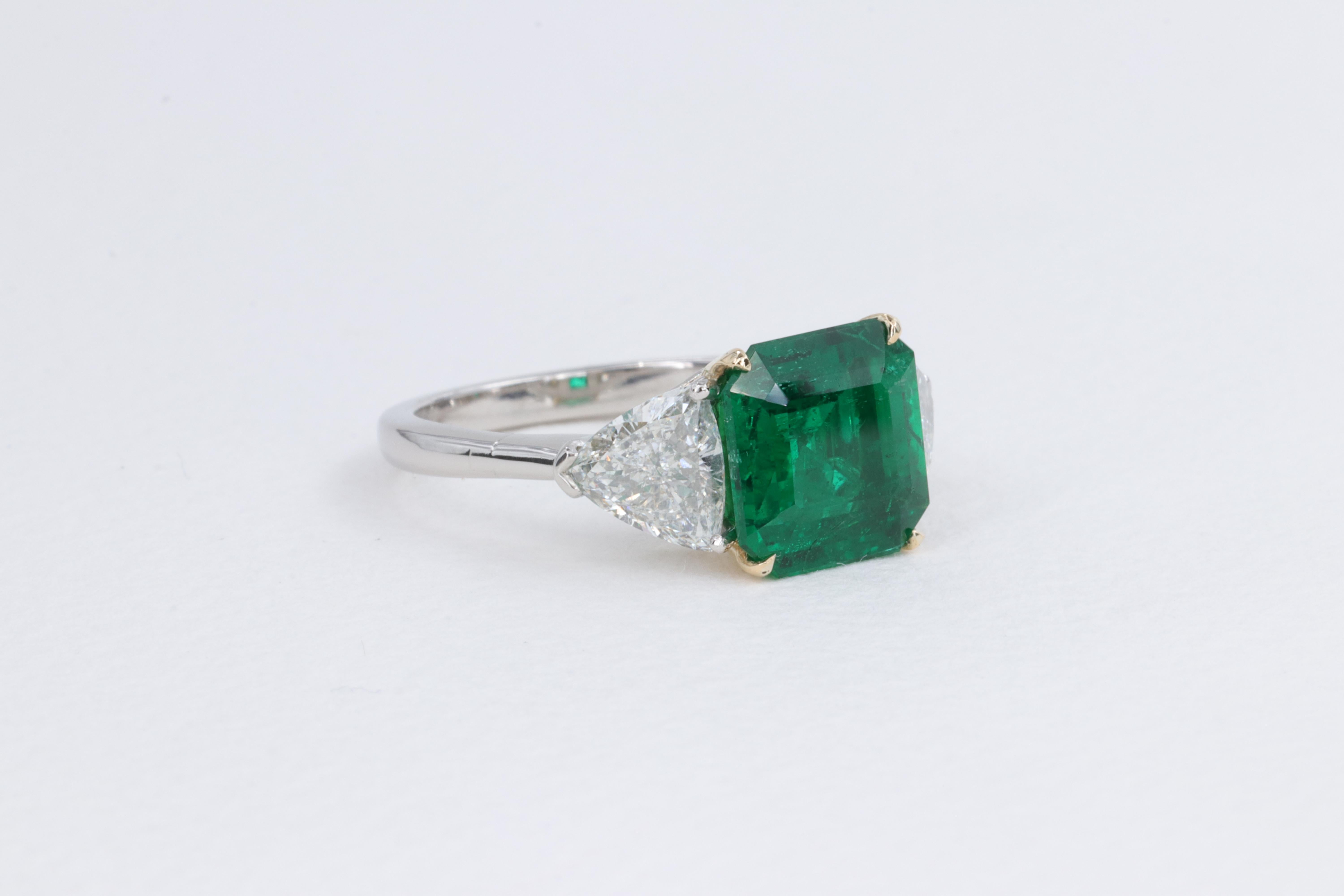 emerald ring with trillion side diamonds