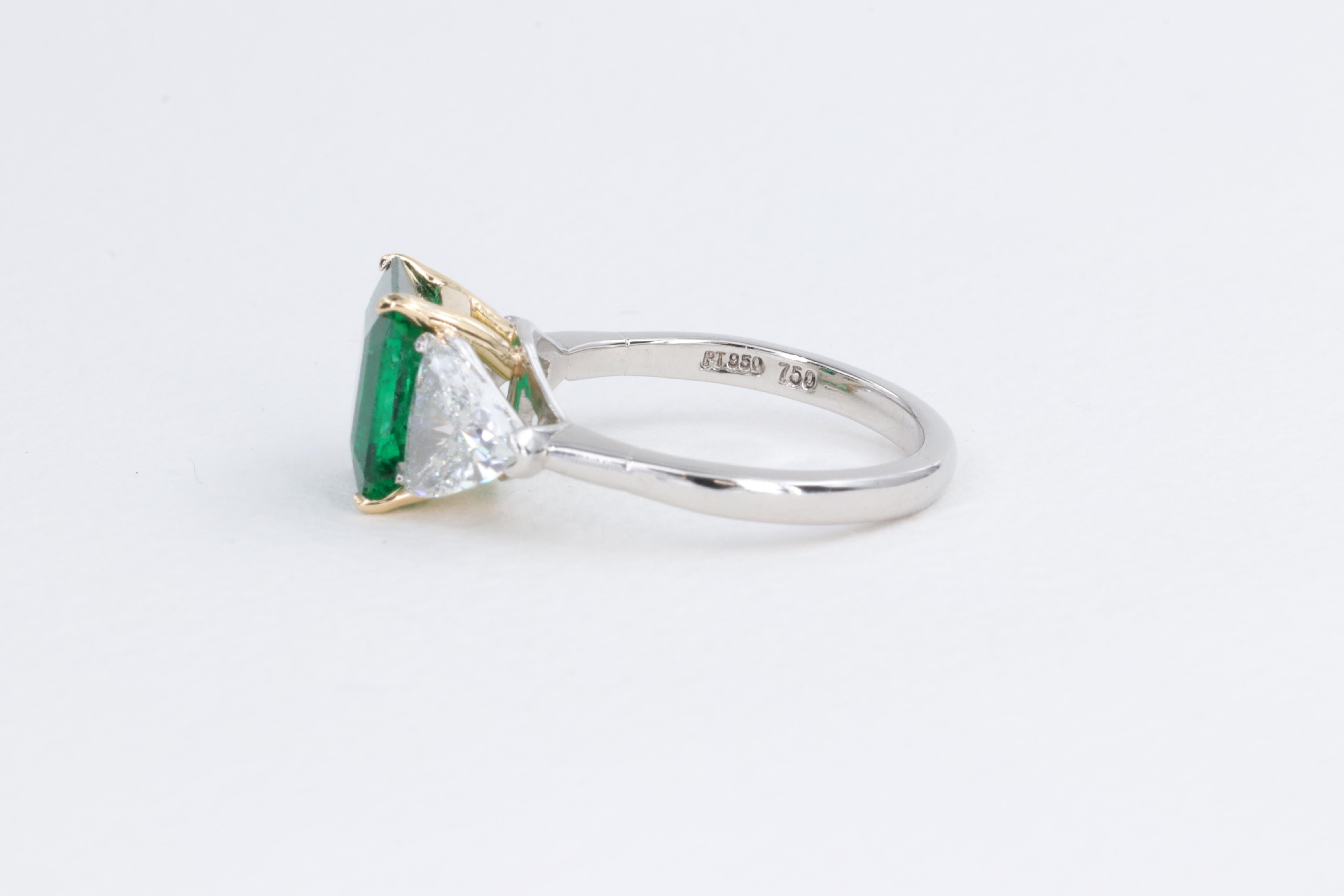 Emerald Cut 2.78ct Minor Oil Emerald A.G.L. Three Stone Ring with G.I.A. Trillions