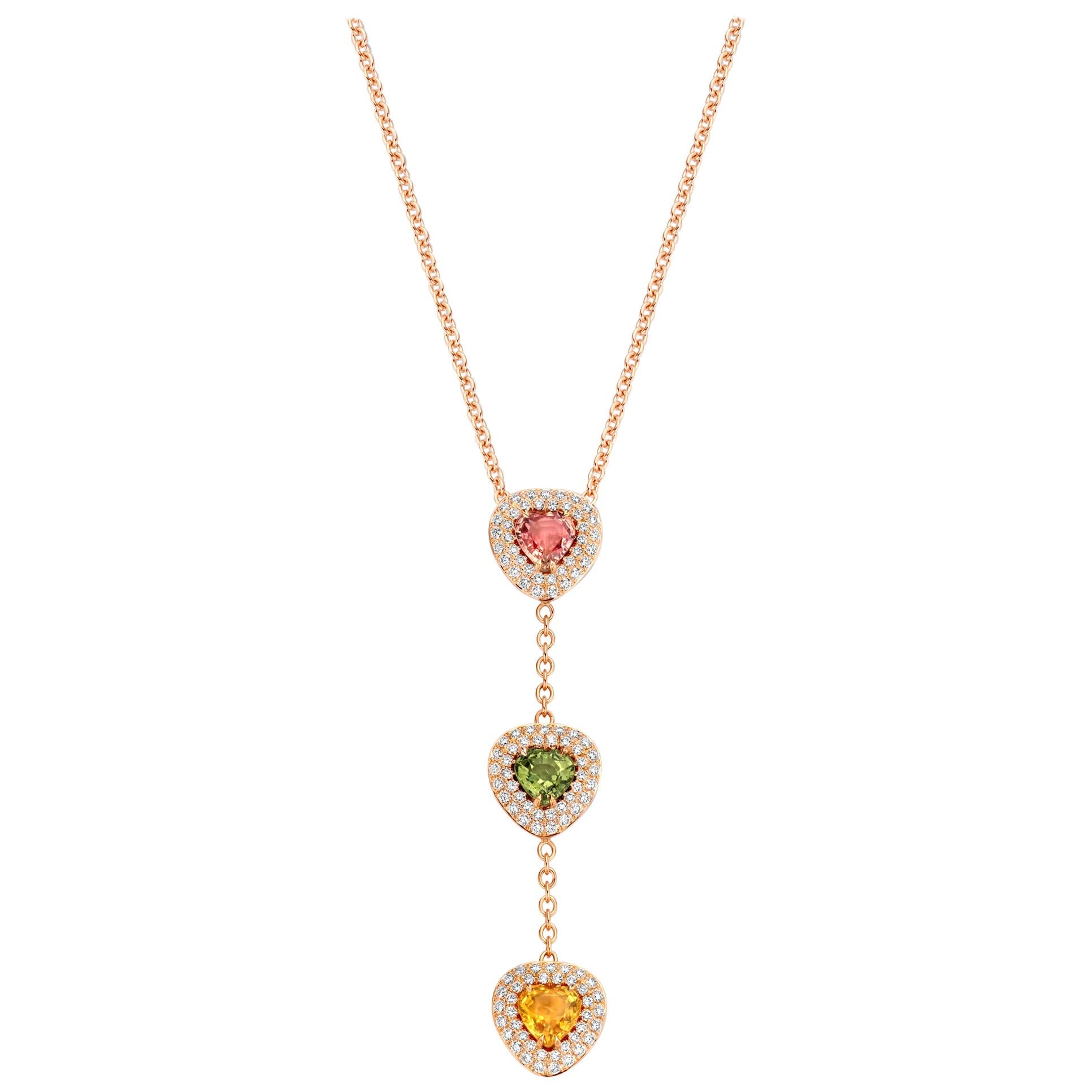 One of a kind three-stone “Didi” necklace in 18K rose gold 9,8g set with the finest diamonds in brilliant cut 0,82Ct (VS/F quality) and 3 natural pink, green & purple sapphires in heart cut 2,79Ct. The chain is 42cm long incuding an adjustable eye