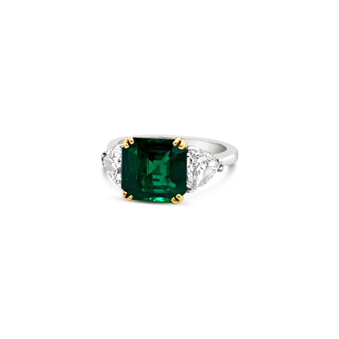 2.79 Carats Emerald Ring, side set with 1.50 Carats (total weight) Trillion Cut Diamonds.  Set in Platinum with 18K Yellow Gold center prongs.
