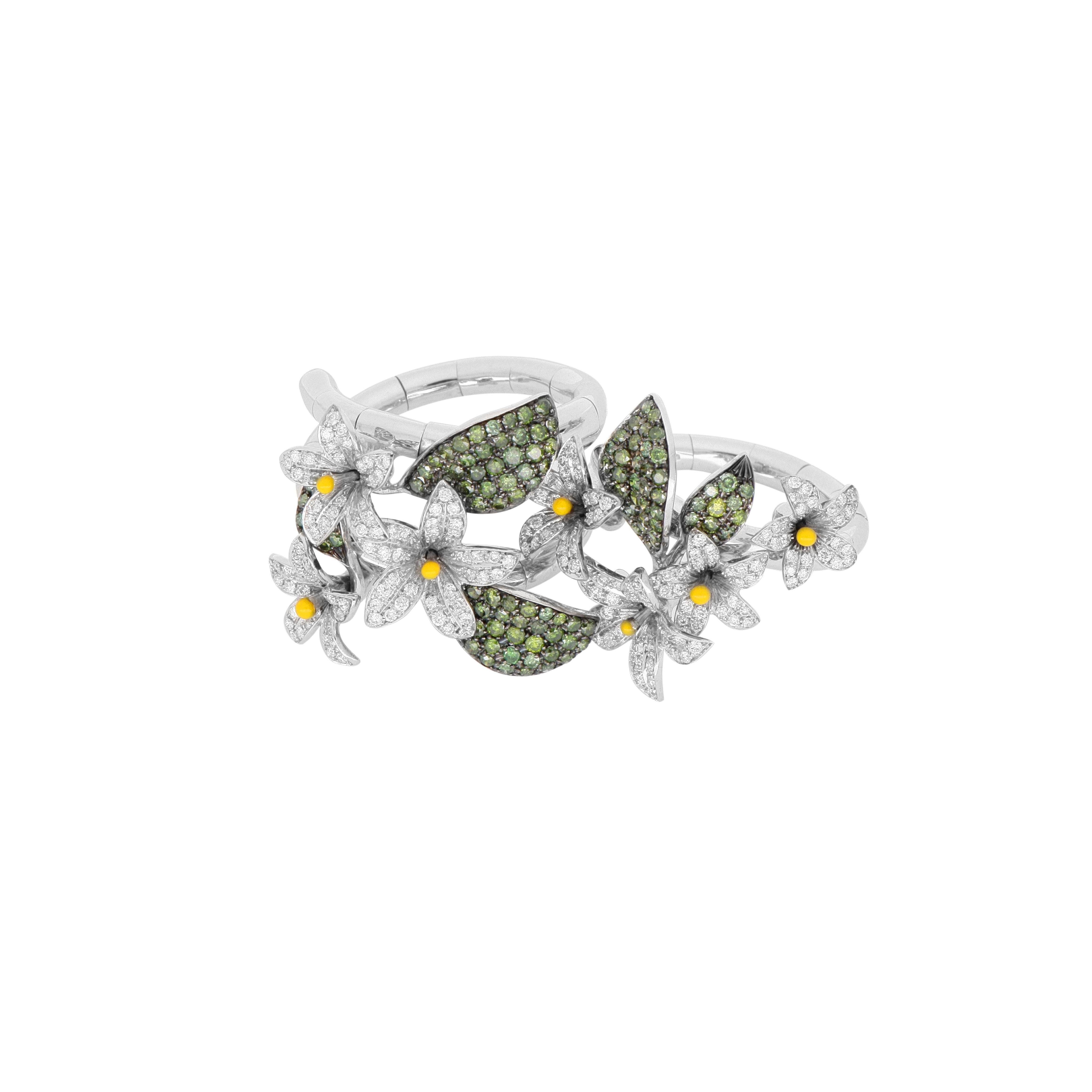 Crafted in 18Kt white gold, this beautiful spiral ring is inspired by Arabian Star Flowers. It features multiple diamond-pavé flowers and green diamond leaves. Perfect if you're after a fresh, cheerful look for spring and summer. For a matching set,