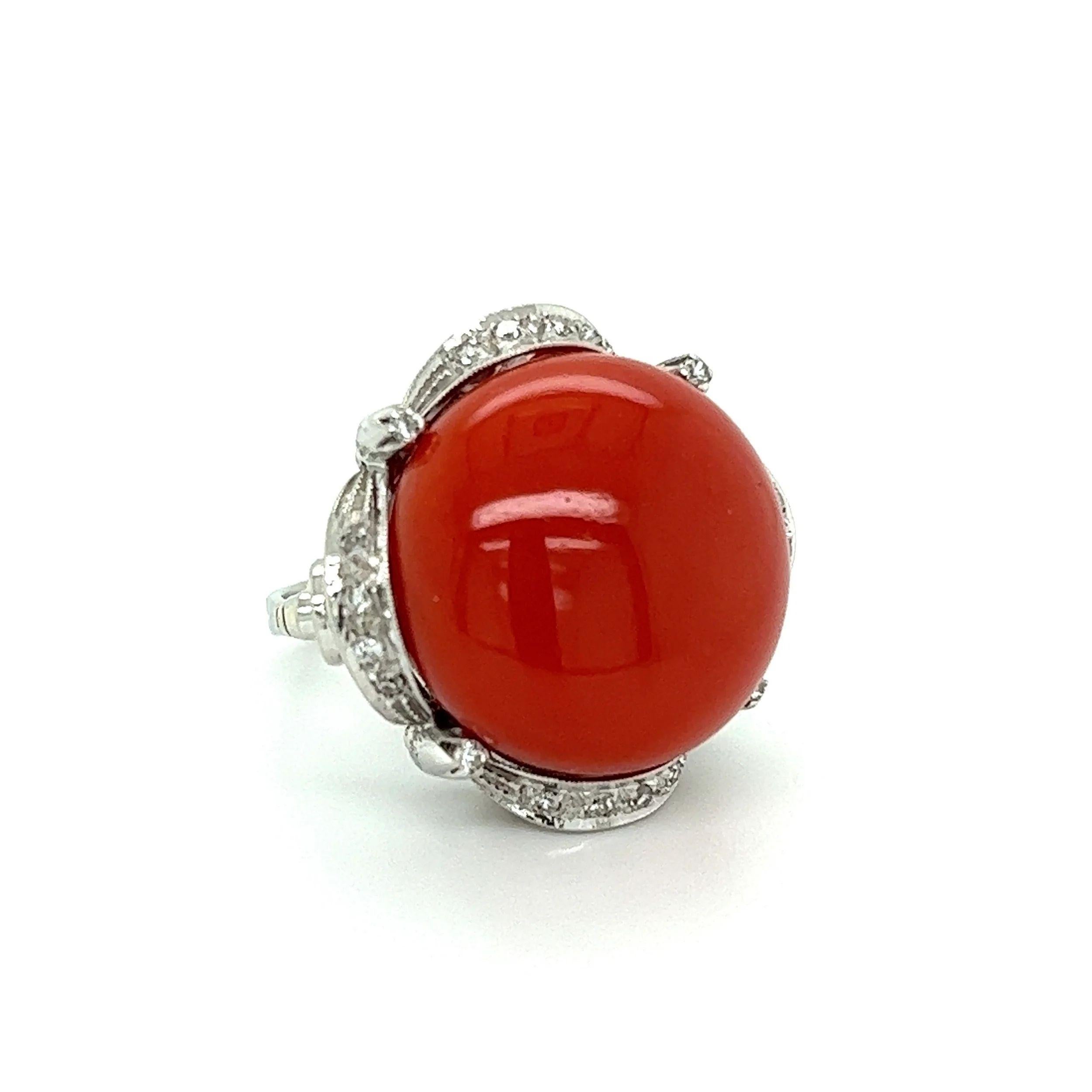 Simply Beautiful! Finely detailed Cabochon Red Coral and Diamond Gold Cocktail Ring. Centering a securely Hand set Awesome 27.90 Carat Cabochon Red Coral, artfully surrounded by Diamonds, weighing approx. 0.16tcw. Hand crafted 14K Yellow Gold