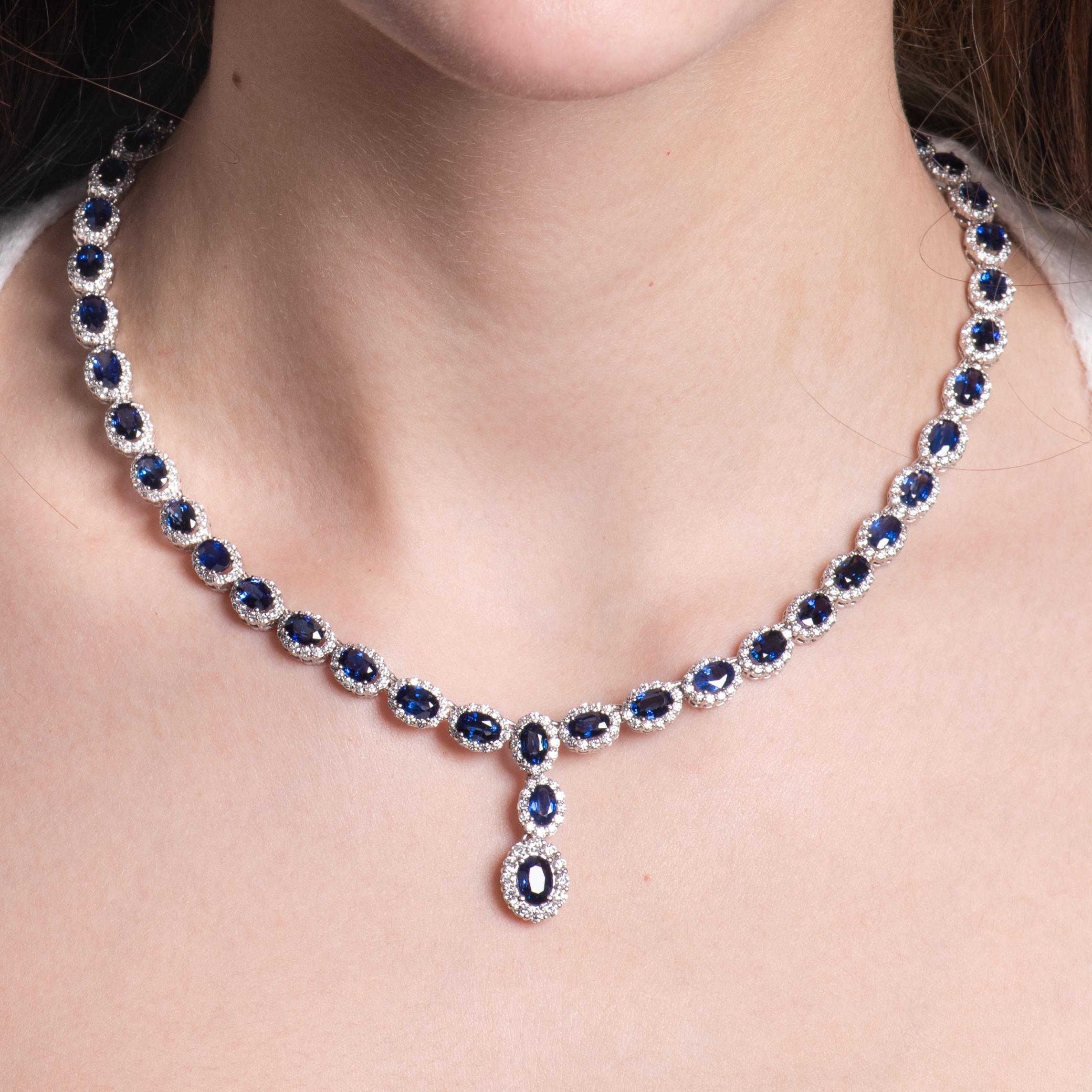 This exquisite necklace features 27.95ct total weight in oval cut sapphires of rich, royal blue hue, accompanied by round diamond halos with a total weight of 7.08ct. All the stones are set in a 16 inch 18kt white gold necklace. The stones go all