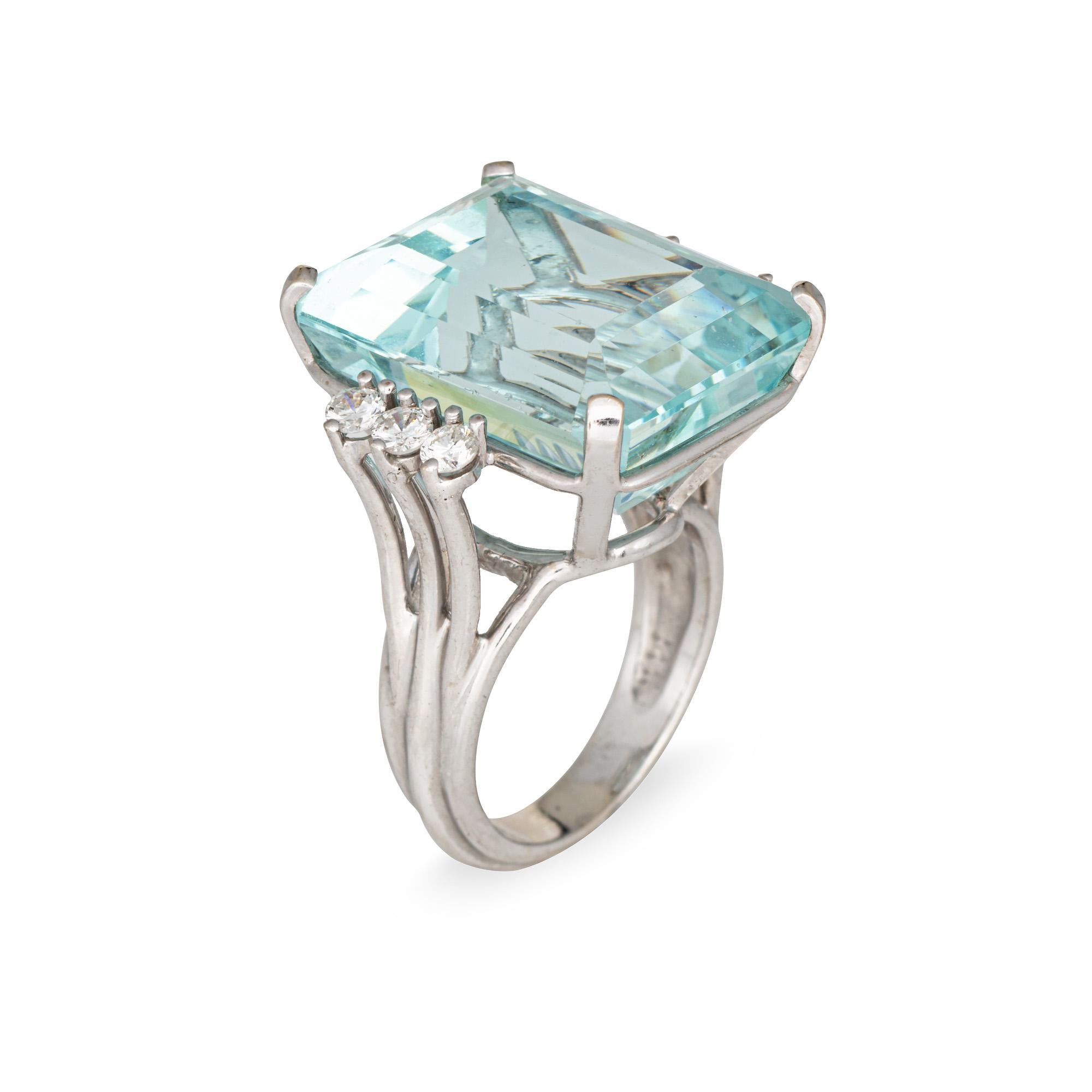 Stylish vintage aquamarine cocktail ring (circa 1980s) crafted in 14k white gold. 

Emerald cut aquamarine measures 20mm x 16mm (estimated at 27 carats). The aquamarine is in good condition (few tiny flea bite chips visible under a 10x loupe). 6