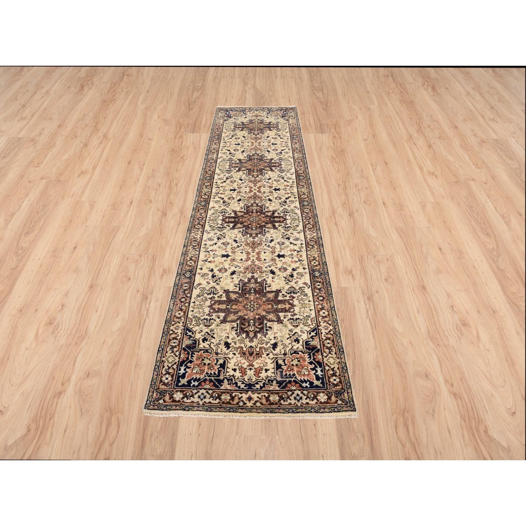 This is a truly genuine one-of-a-kind Beige Antiqued Heriz Re-Creation with Geometric Medallions Extra Soft Wool Hand Knotted Oriental Runner Rug. It has been Knotted for months and months in the centuries-old weaving craftsmanship techniques by