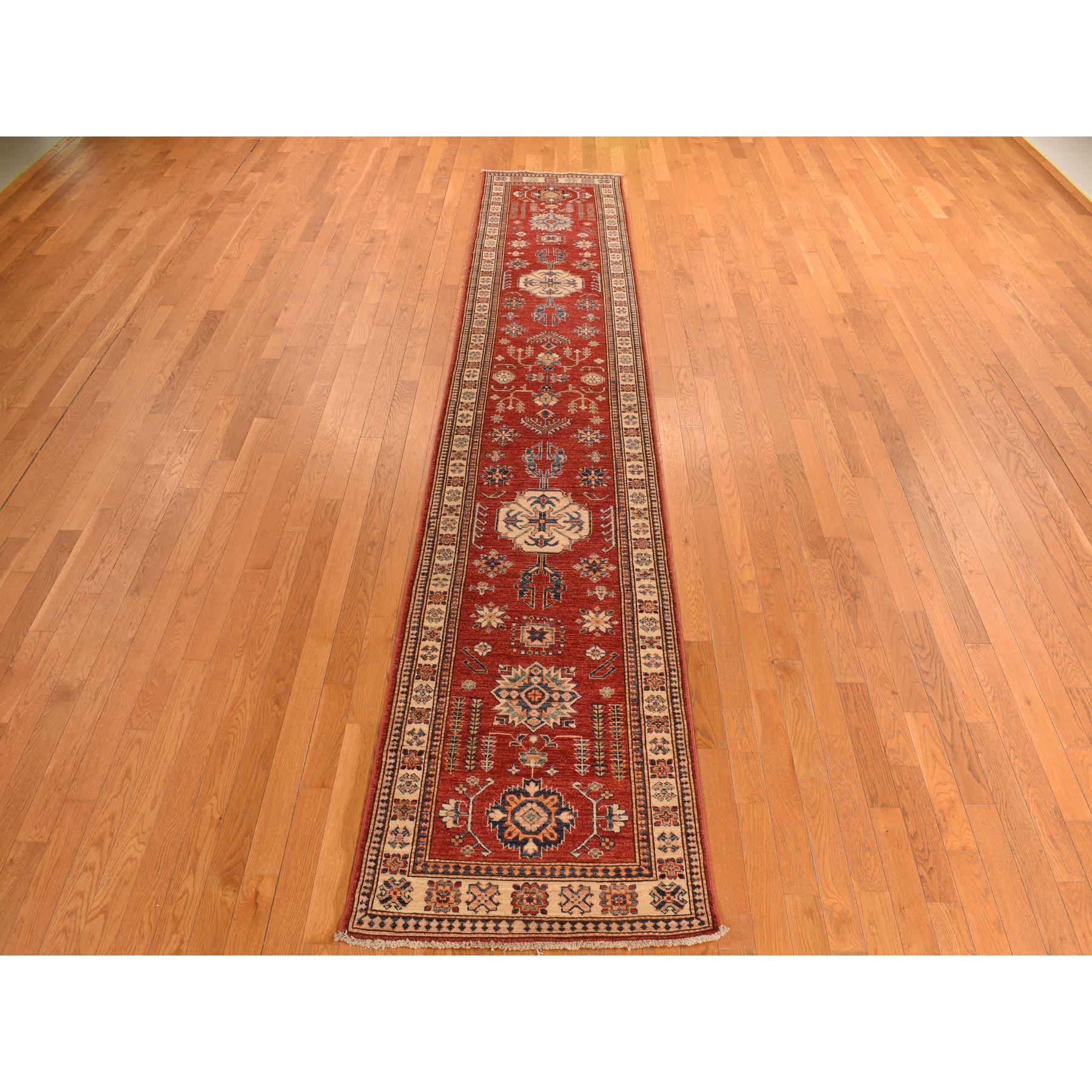 Carnelian Red, Afghan Super Kazak, Hand Knotted, Shiny Wool, Vegetable Dyes, Runner, Oriental Rug
Primary materials: Wool
Latex: No Pile 
height: 0.25 Inches
Style: Traditional
Primary color: Red
Secondary colors: Blue, Green, Orange
Pattern: