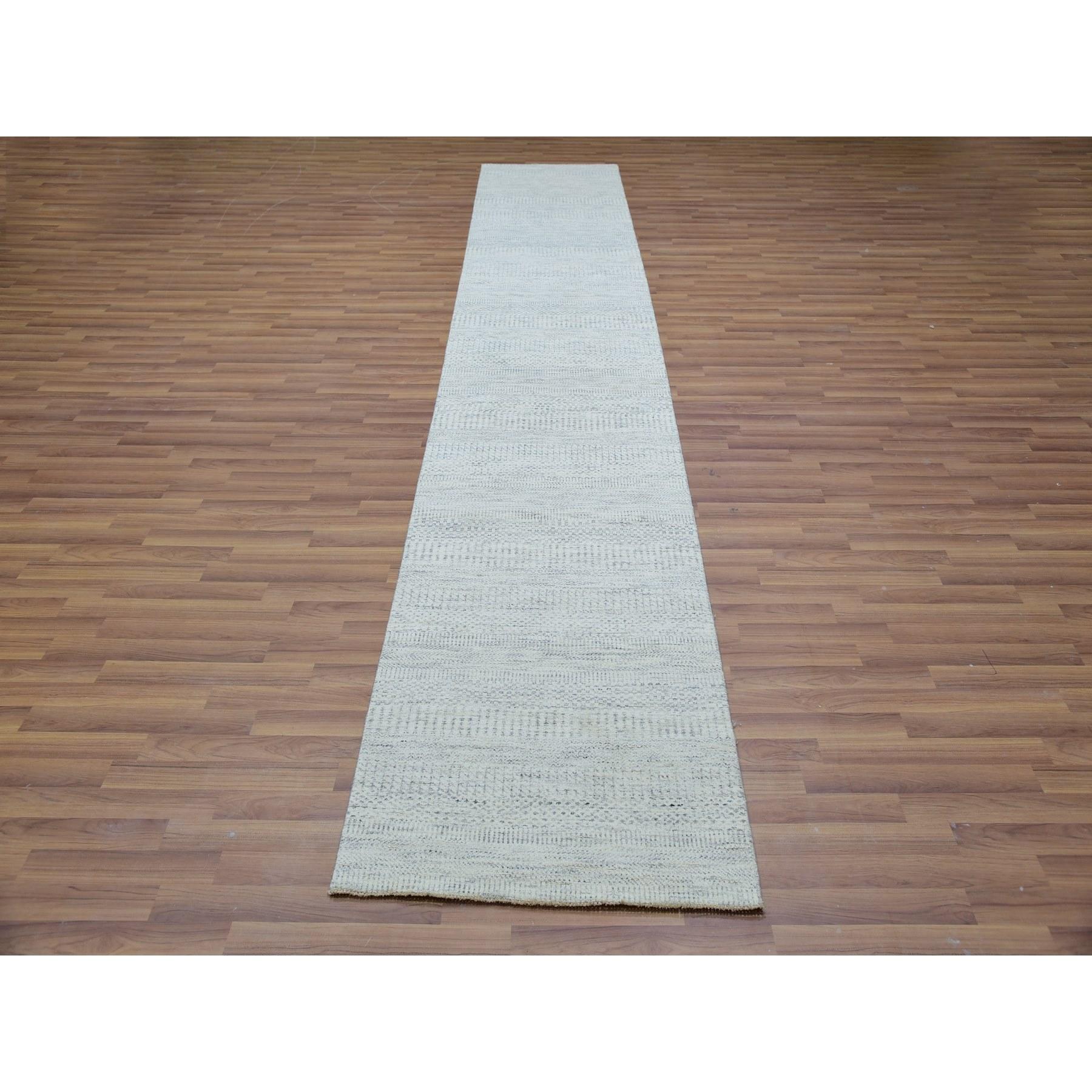 Il s'agit d'un véritable tapis d'Orient en pure laine non teintée, ton sur ton, au design moderne de graminées, noué à la main. Il a été noué pendant des mois et des mois par des artisans selon des techniques de tissage séculaires.
Matières